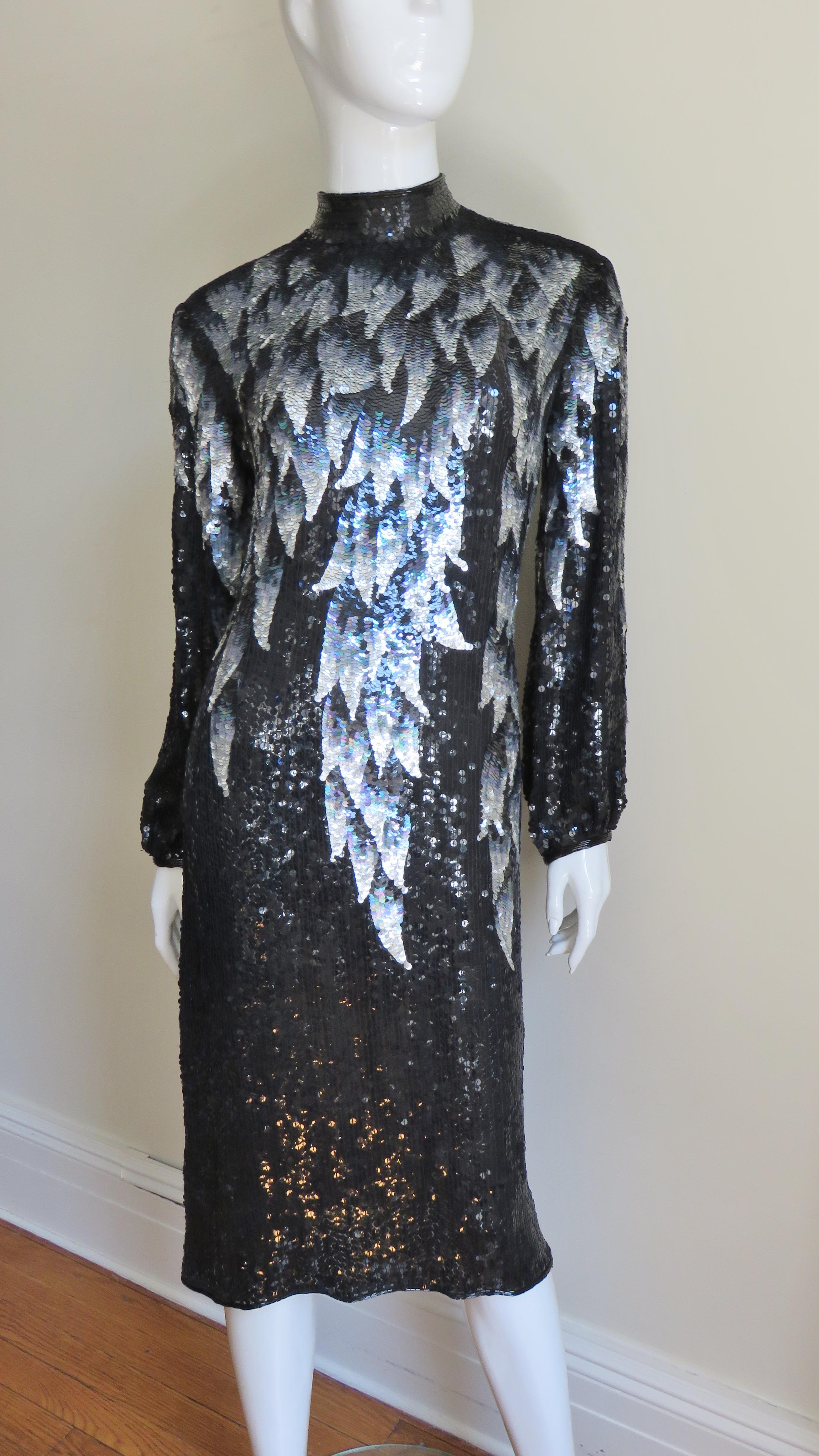 A fabulous black sequin silk dress from Halston.  The background is comprised of black sequins throughout the dress with an elaborate sequin pattern in shades of grey and silver raining down from the top of the dress front, back and sleeves.  The