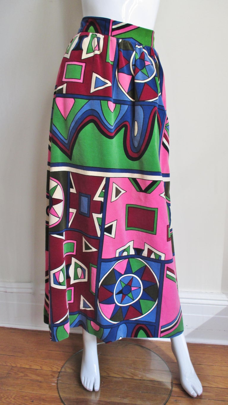 A fabulous brightly colored abstract pattern velvet maxi skirt from Mignon in pink, green, burgundy and blue. The skirt is gathered onto a 2