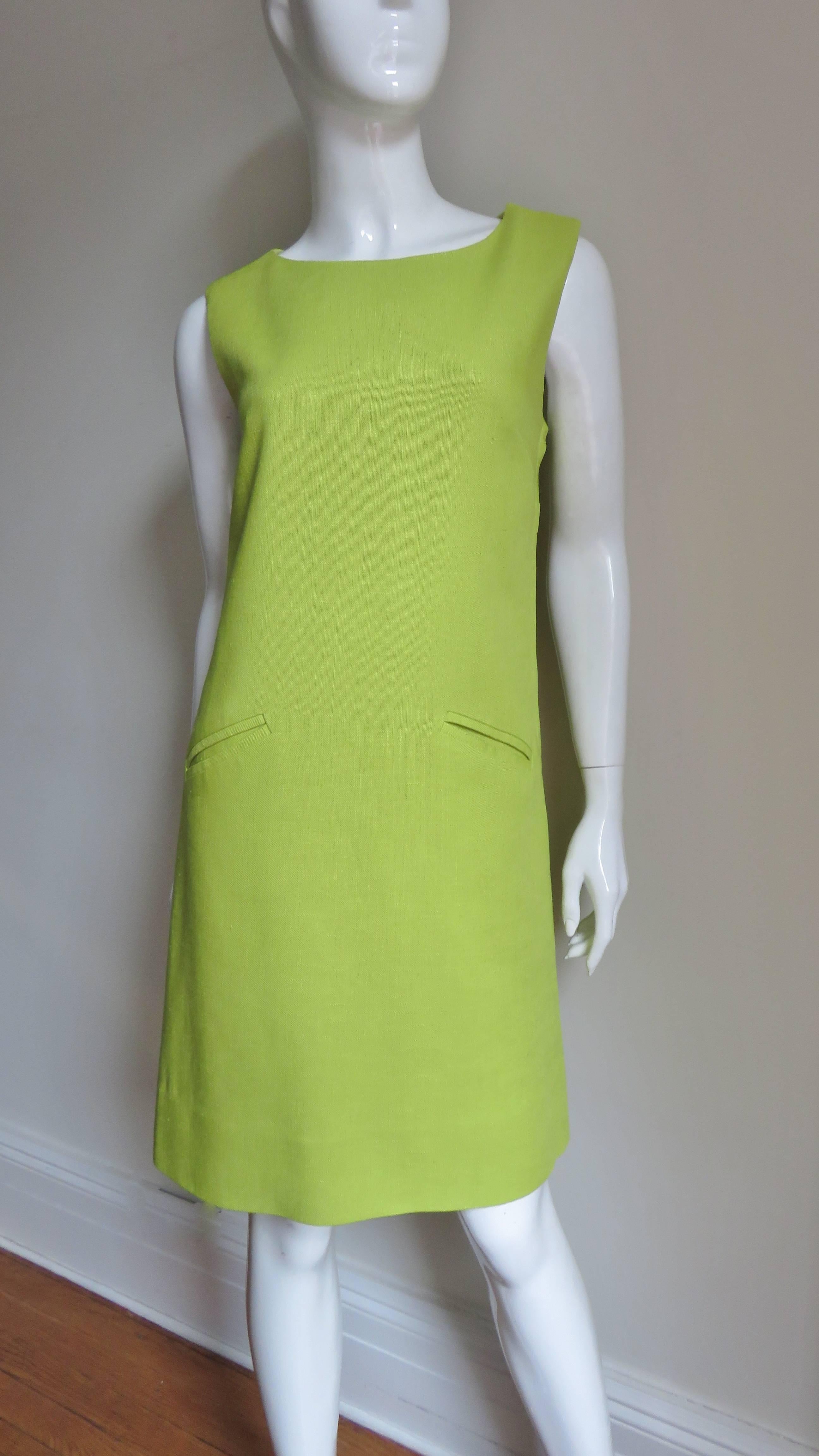 A mod 1960s dress in yellow green linen by B. H. Wragge.  It is a simple sleeveless A line with a fabulous cut out flower on the back covered in matching sheer silk and front angled pockets at hip level.  It is lined in matching silk, has a side