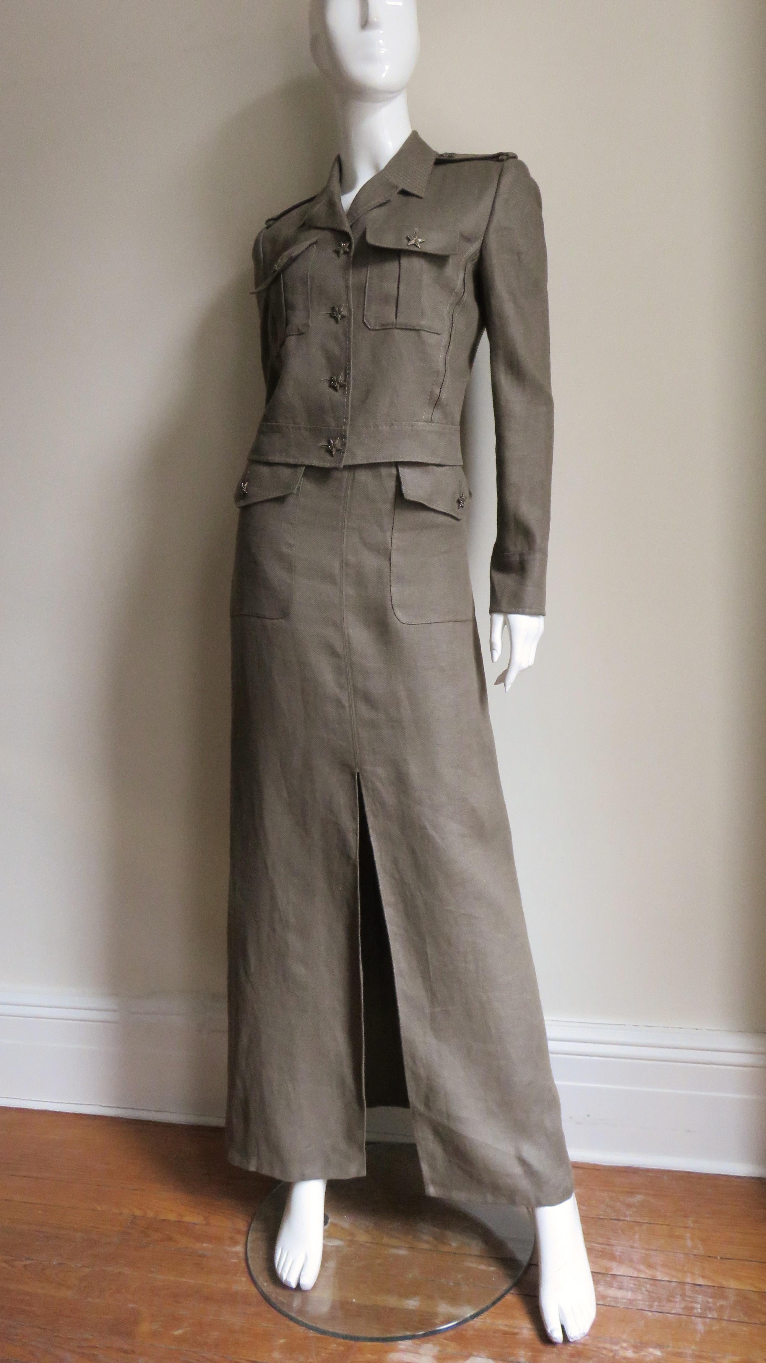 A gorgeous olive green linen jacket and skirt set from Valentino. The hip length vertical seamed jean style jacket has front button flap patch pockets and a small notched lapel collar. There are epaulets on the shoulders, long button cuff sleeves