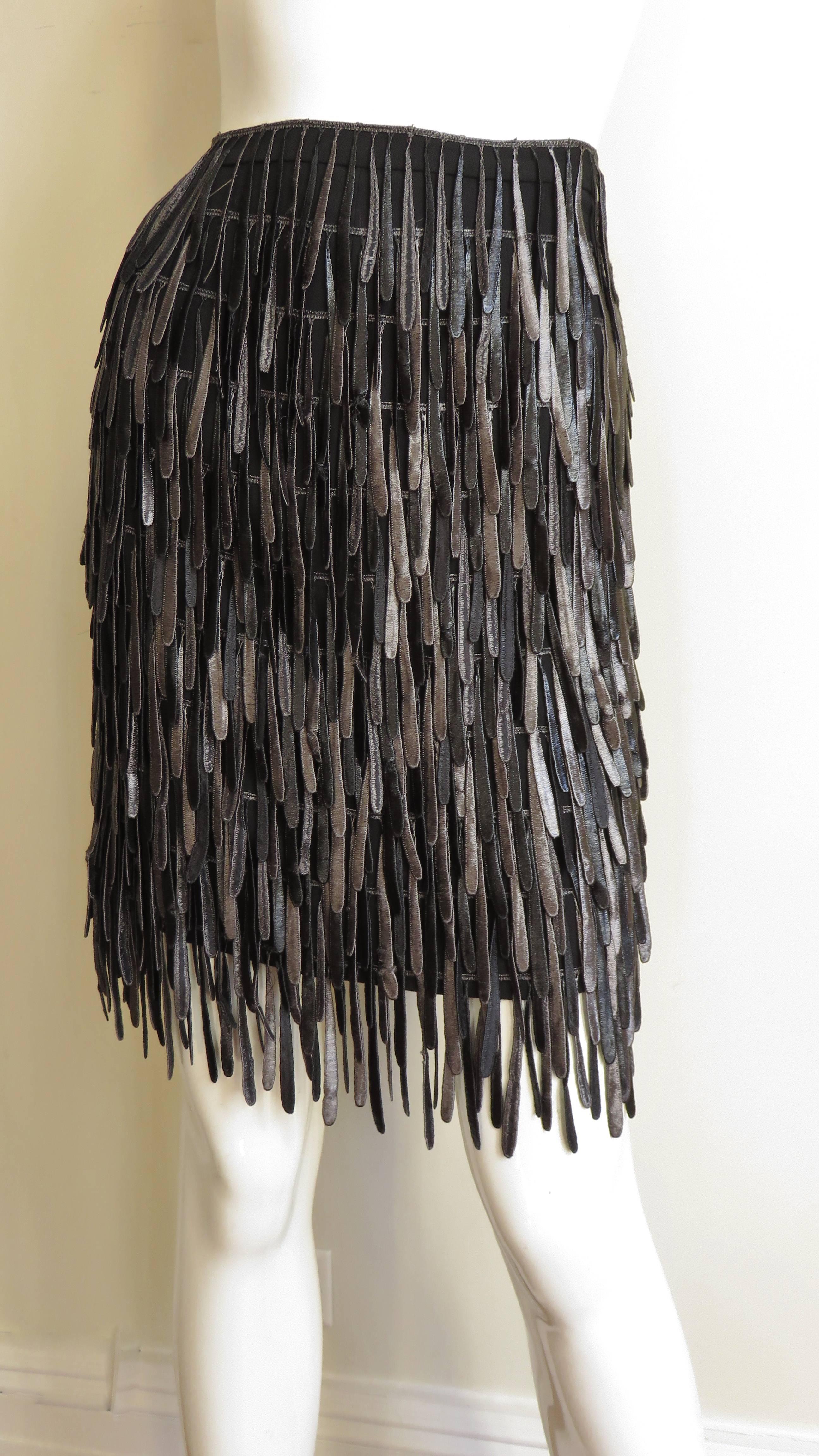 A fabulous silk fringe skirt from Fendi.  It is a straight black skirt covered in rows of 3