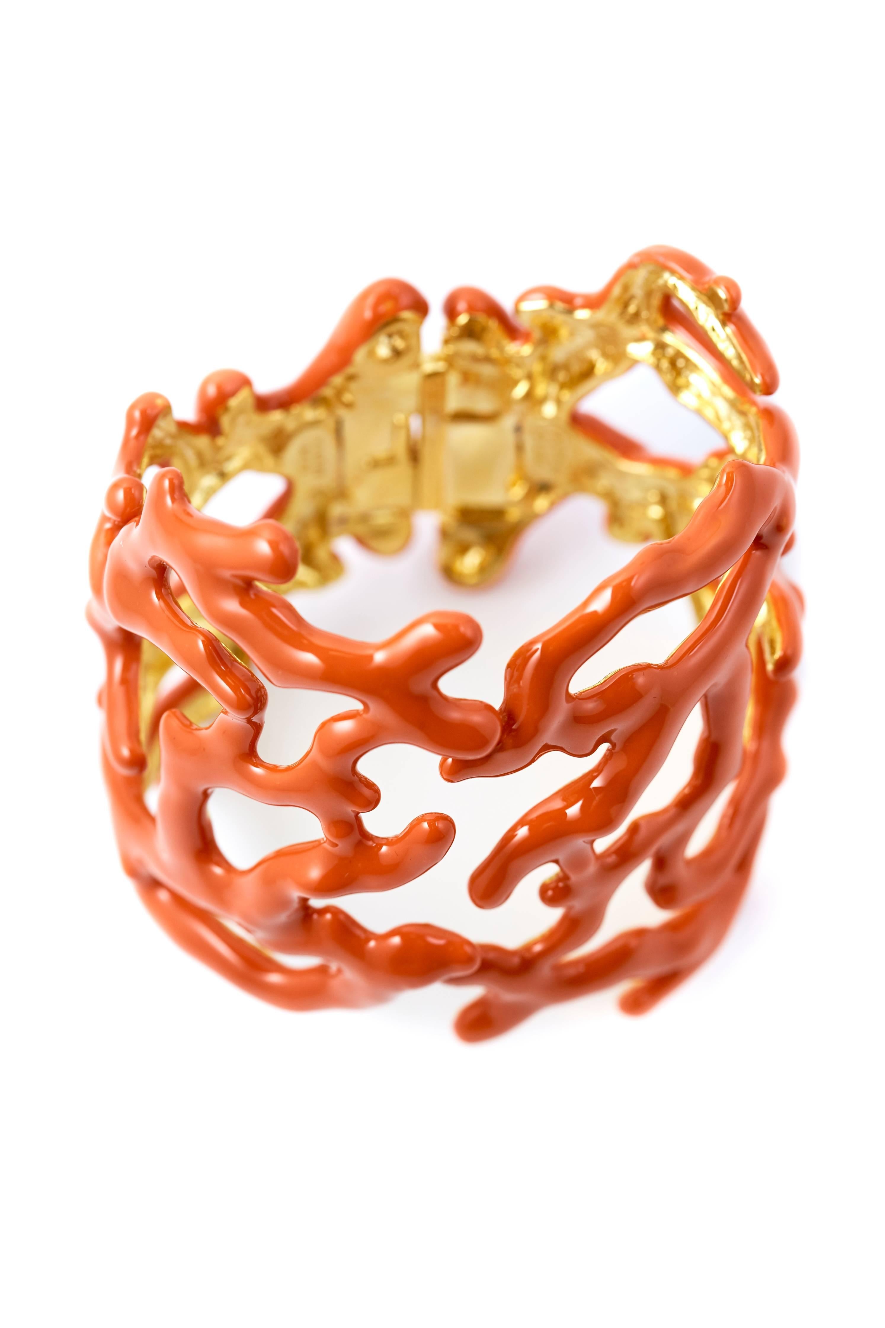 

Kenneth Jay Lane Coral enamel cuff. Hinged and adjustable for the perfect fit.
Inner measuremnts 60 mm x 55 mm