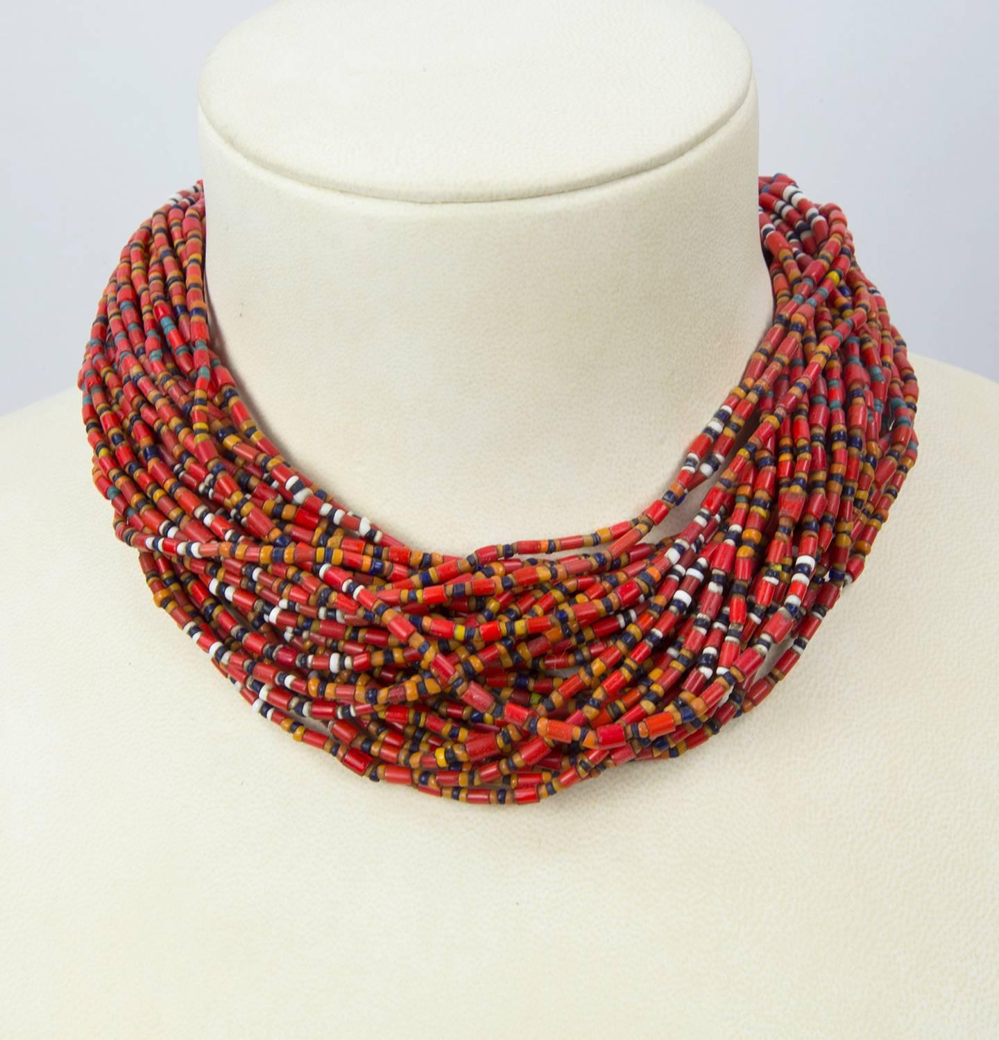 Sensational Necklace in its 36-strand display of multi Tribal Glass Beads; These high-grade beads measure approx. 5mm x 3.5mm; The strands meet at handmade triangular cones, interwoven with the glass beads and ending with a circular Silver coin