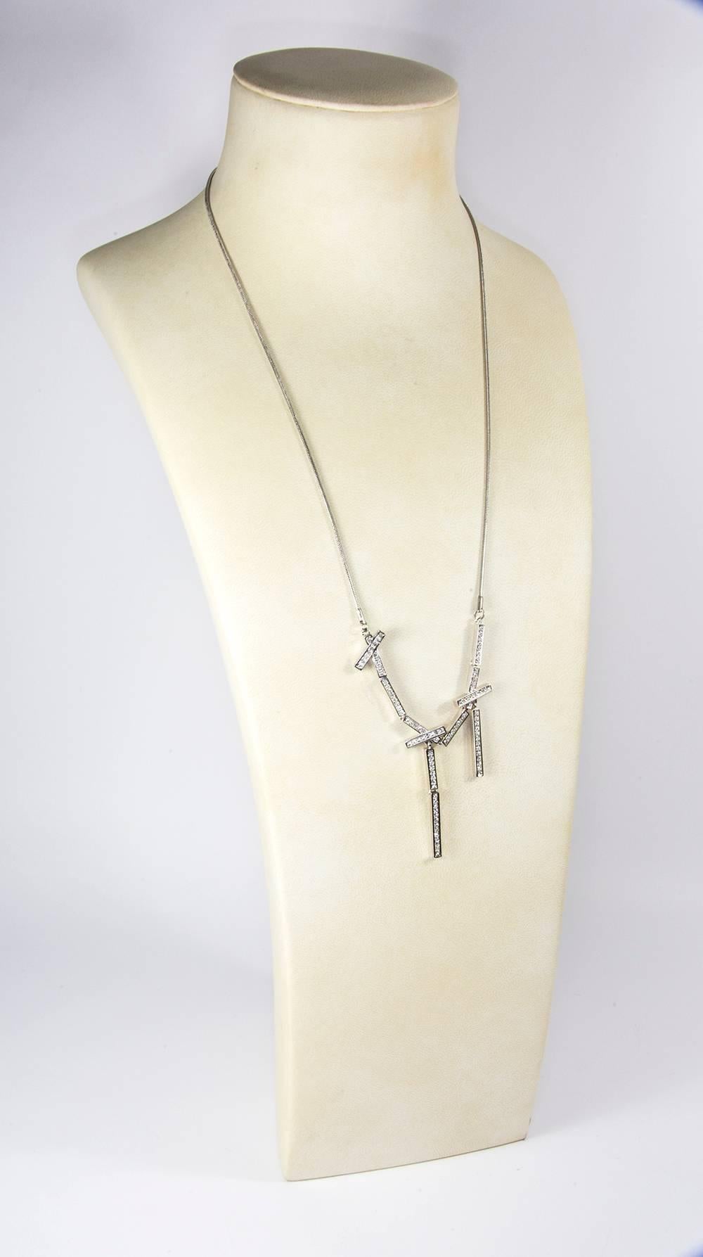 Simple and Dynamic Stainless Steel flexible Multi Bar CZ encrusted Pendant Necklace; chain measures approx. 23” long; drop is 4” long. Chic and Timeless, Illuminating your Look with a touch of Class! 
