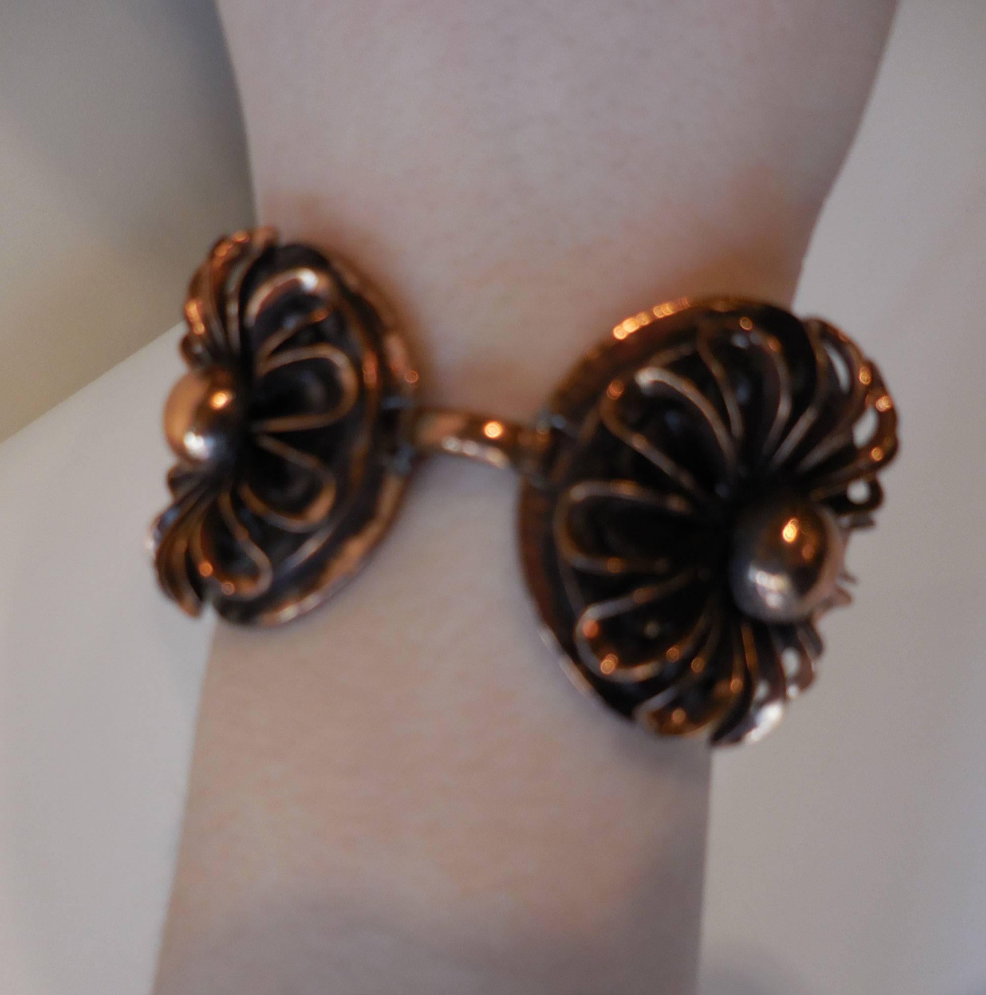 Modernist copper bracelet by Francisco (Frank) Rebajes, comprising twin floral links joined with loop, and foldover clasp; signed to reverse. Apart from the beauty of this piece, its copper content is believed to have properties for arthritis. Wear