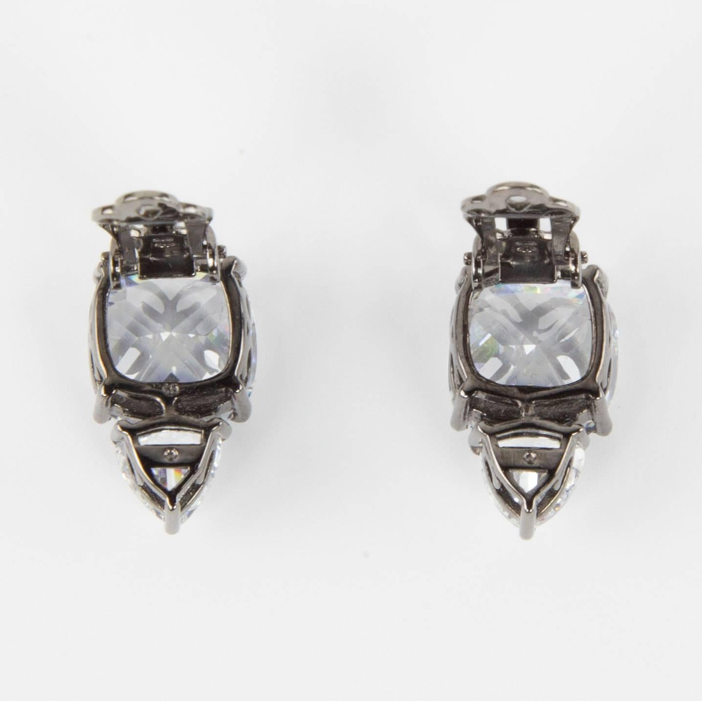 Simply Beautiful…each earring is set with a Trillion and Cushion square shaped Sparkling Faux Diamonds, making a striking statement! All hand set in Rhodium Sterling Silver. Approx. total length .75
