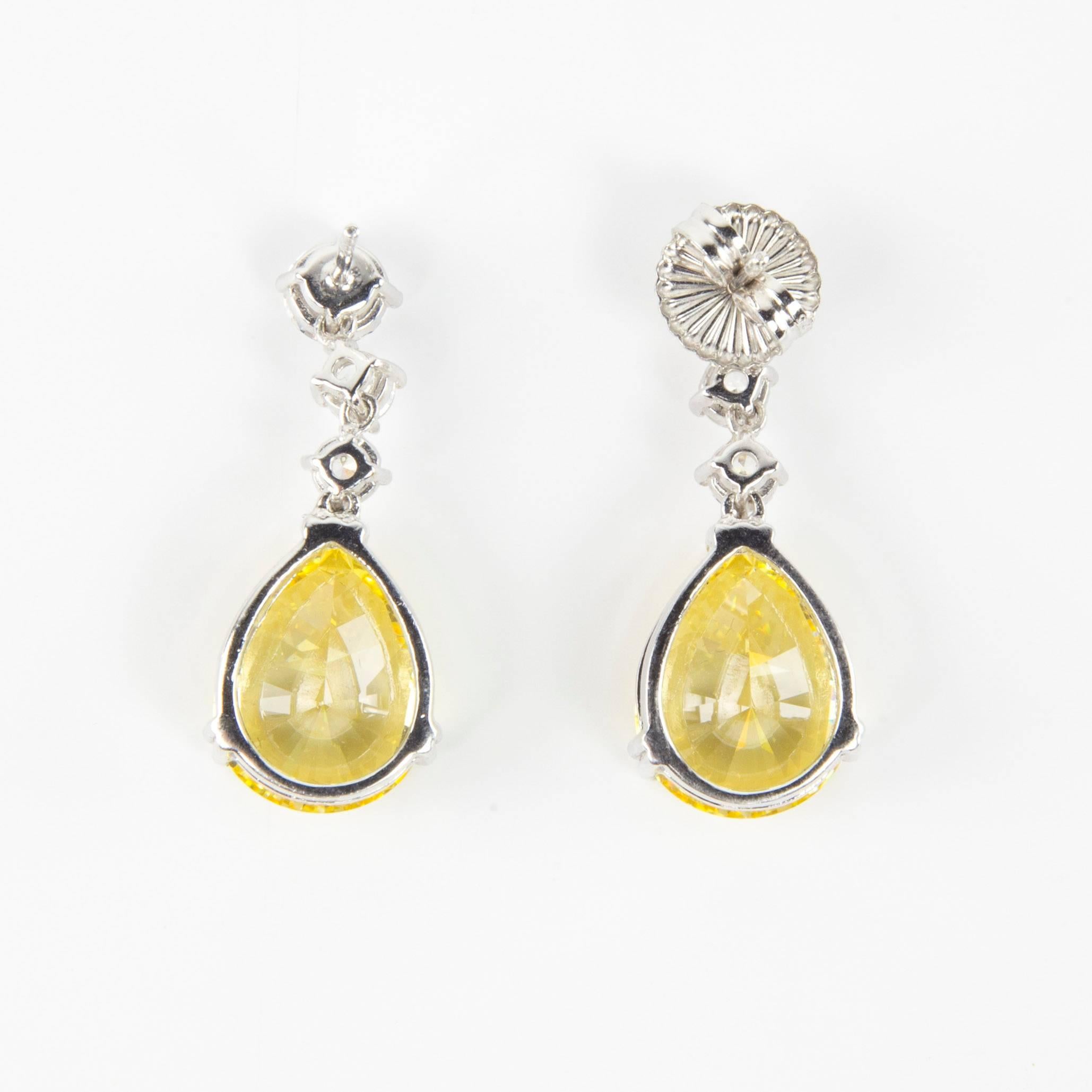Simply Beautiful…each dangle earring is set with a 6mm and two 4mm round Faux Diamonds, suspends a large 16mm teardrop shape faux Yellow Diamond, making a striking statement! All hand set in Sterling Silver. Approx. total length 1.5