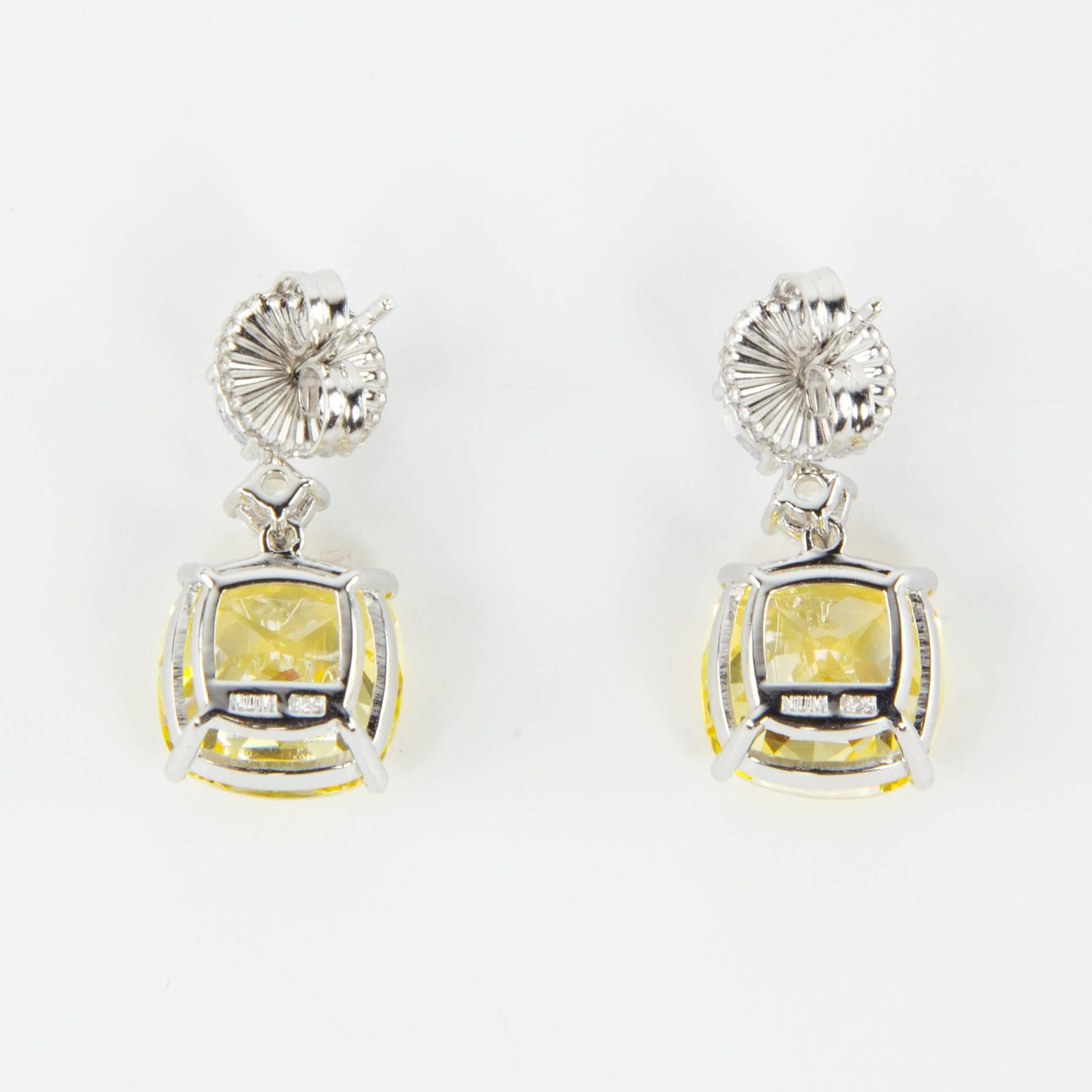 Simply Beautiful…each dangle earring is set with a 6mm and a 4mm round Faux Diamond, suspends a large 22mm square cushion shape faux Yellow Diamond, making a striking statement! All hand set in Sterling Silver. Approx. total length 1