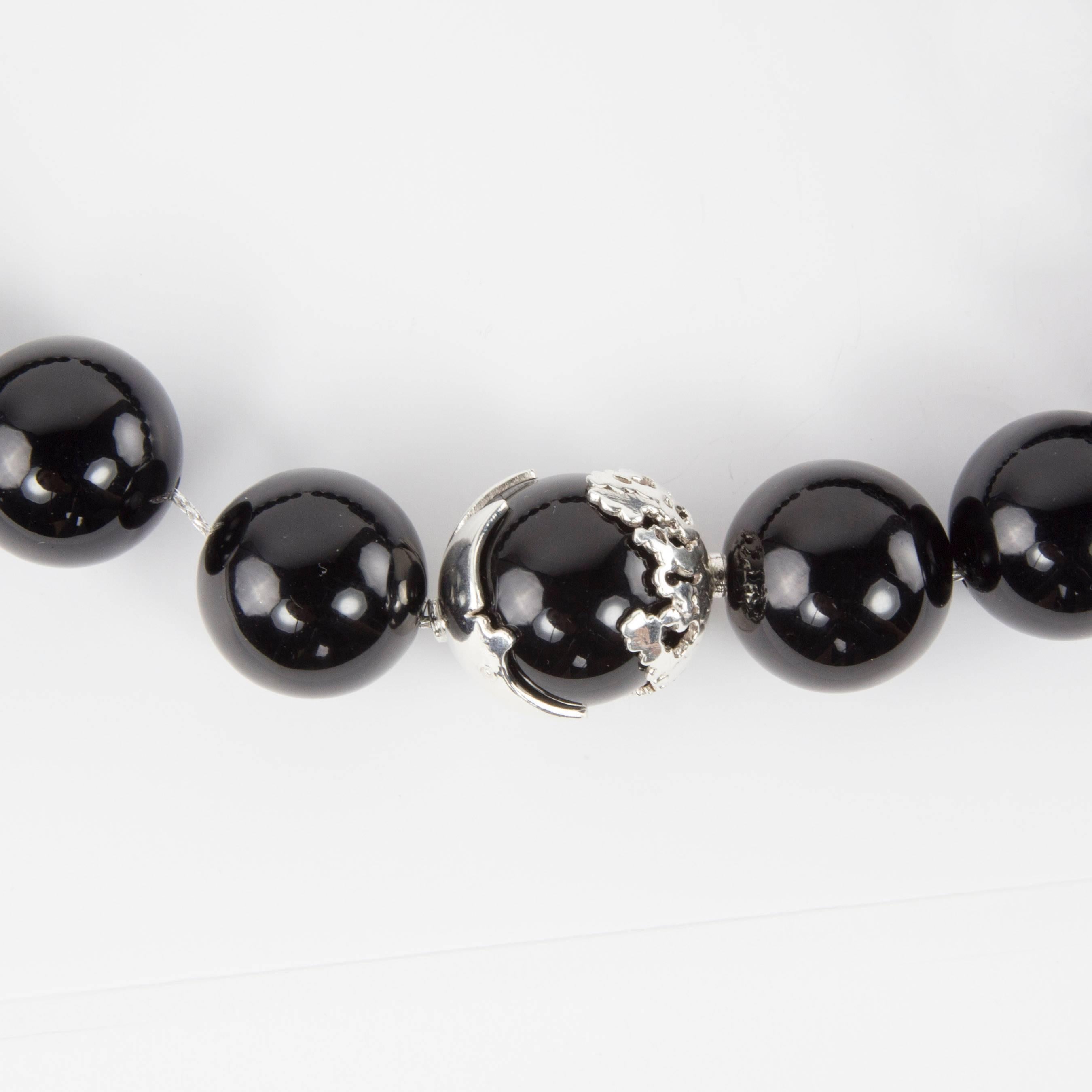 Beautiful Black Onyx Necklace, comprising twenty-one 20mm beads; center bead enhanced either side with decorative Sterling Silver elements, reflecting the moon and stars. Modern and unique, a necklace you'll love to wear every day, Day or Night!
