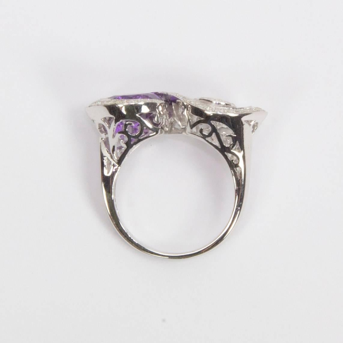 Beautiful Toi et Moi Crossover Swirl design Ring with an Amethyst surrounded by a bounty of glistening Cubic Zirconium; beautiful open gallery; Size 7.5 can be resized on request. Add Pizazz to any outfit!