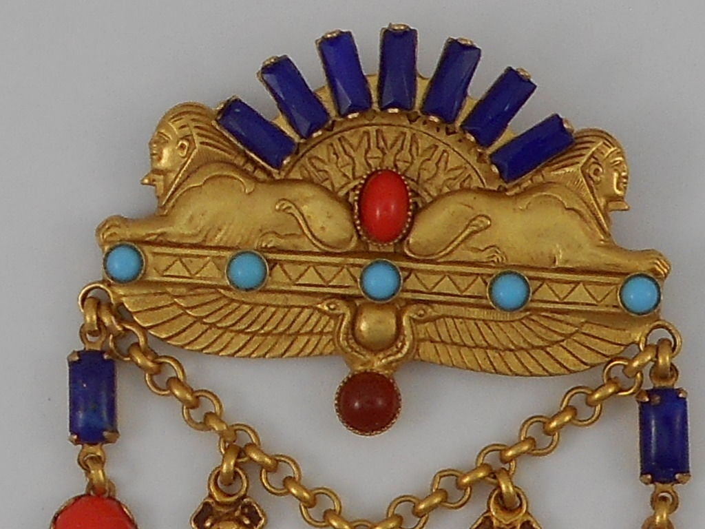 Fabulous!  Askew London signed Brooch; Antiqued Gilt Brass Double Sphinx decorated with Blue glass baguette stones and assorted colored glass Cabochons. Brooch has Drops suspended from a chain of Palm Leaves, Cicadas, a center Drop of Sarcophagus