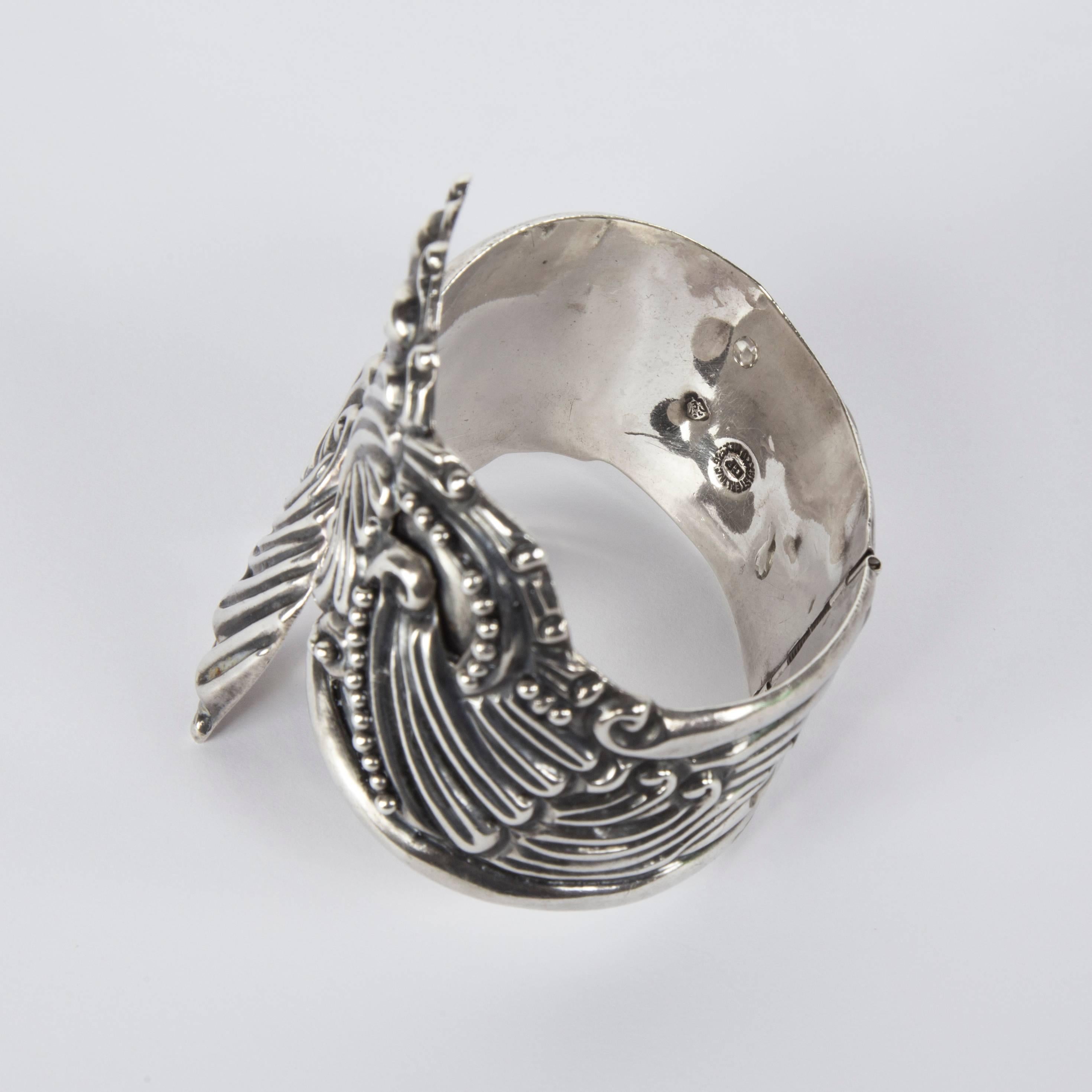 Clamper bracelet featuring flowing Repousse lines with recessed ball accents swirl around the cuff; Interior marked: STERLING 925 TEXCO MEX GP, including an eagle stamp; approx. closed opening size:  2 x 2.25-2.50 inches; hinge system; fits small to