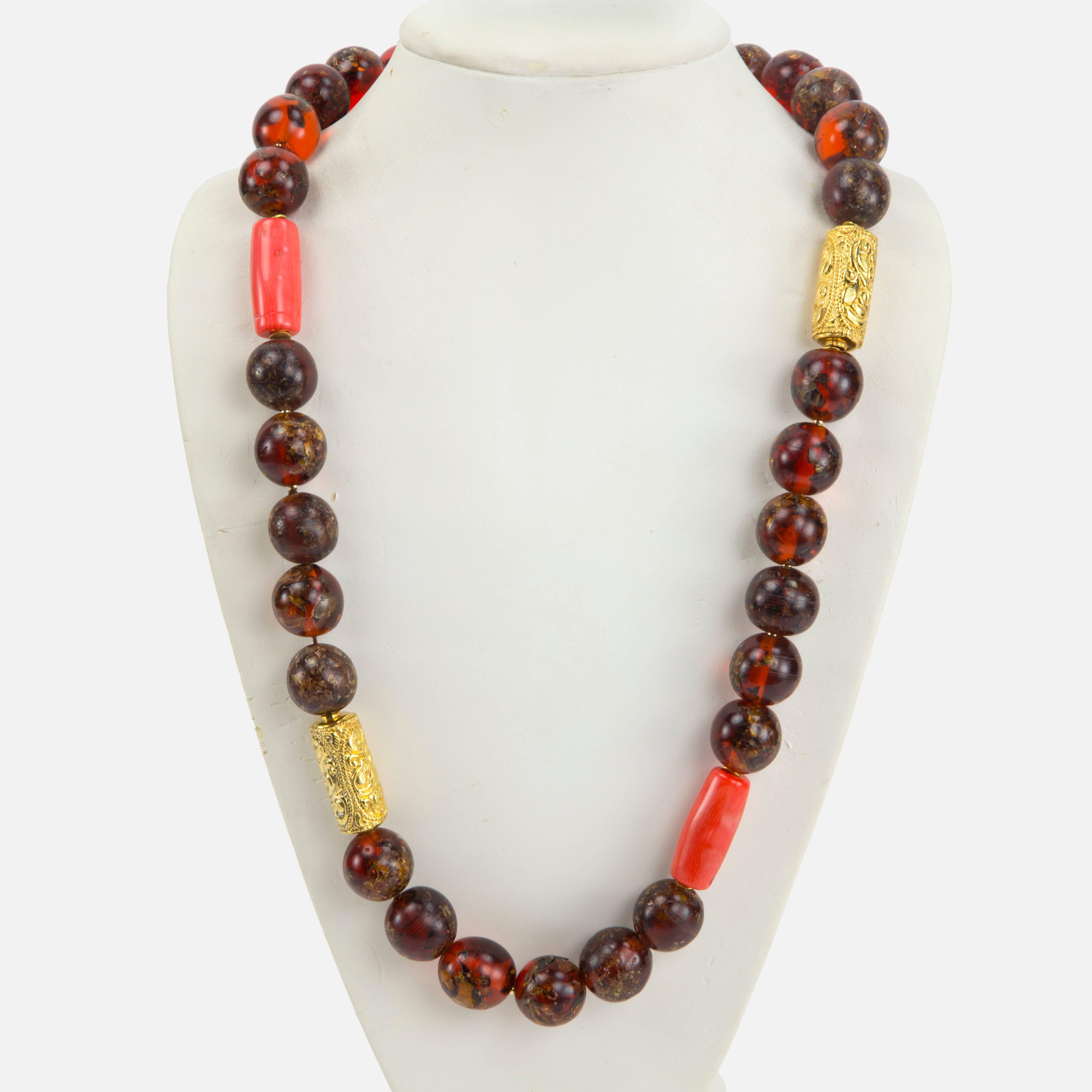 Rare Large Tibetan Natural Copal Amber, Coral and Gold bead Necklace…Beautiful in its simplicity! Length of necklace 30”; 3 coral beads, each approx. 1.25” long x .75” diameter; 29 amber beads; each approx. 19mm-20mm and 2 gilt tubular embossed