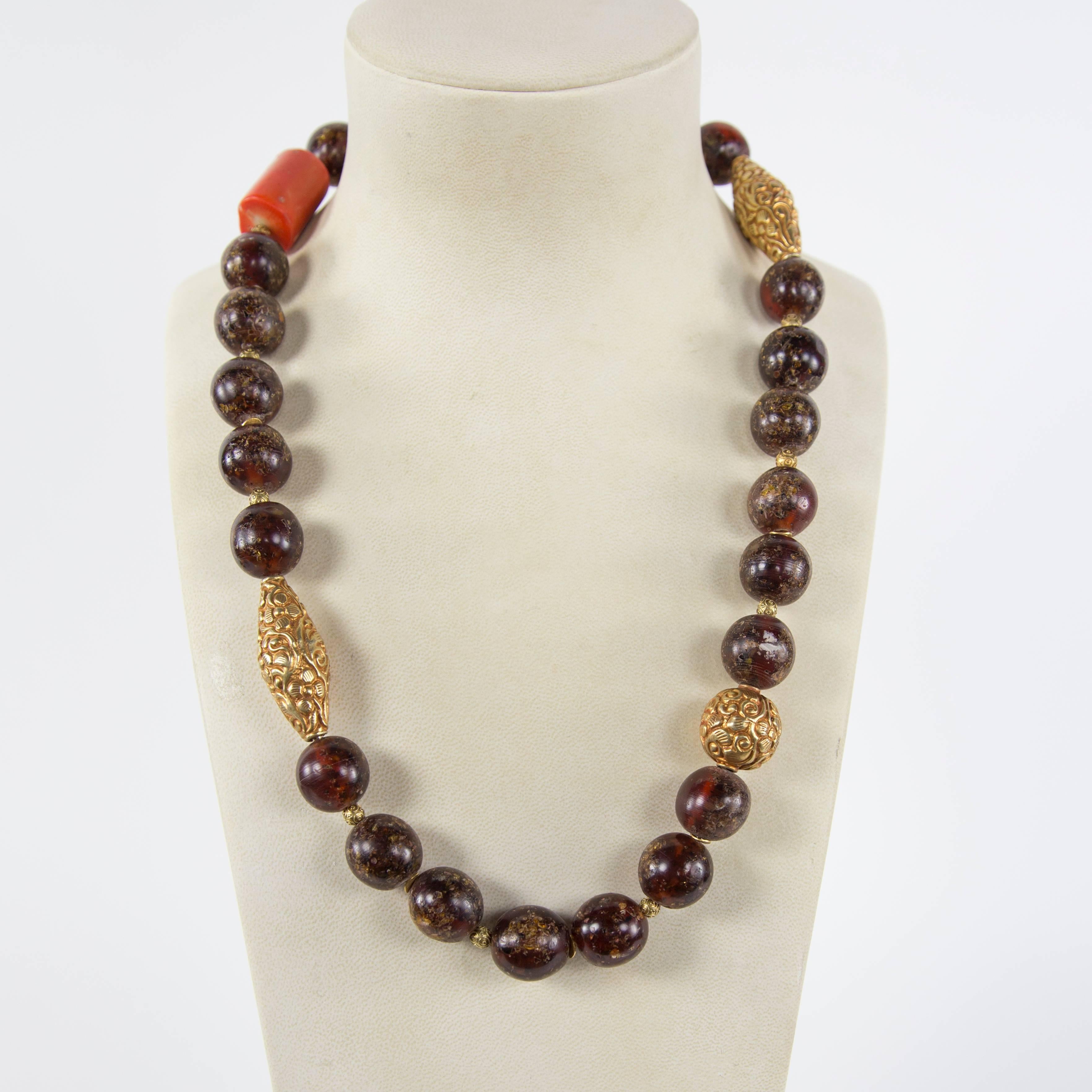 Rare Large Tibetan Natural Copal Amber, Coral and Gold bead Estate Necklace…Beautiful in its simplicity! Length of necklace 28”; 1 coral bead, approx. 1.25” long x .75” diameter; 25 amber beads; each approx. 19mm-20mm and 3 gilt brass beads.