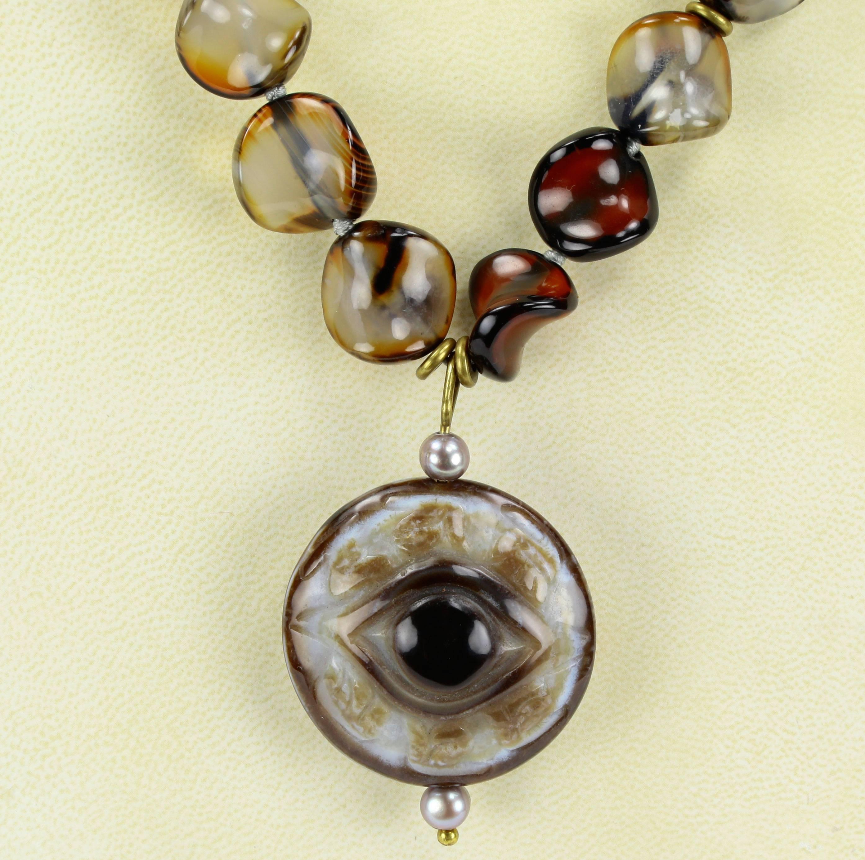 Outstanding Unique ‘Thump grip’ Carnelian and ‘Evil Eye’ Runway Pendant Necklace, suspending a large round ‘Evil Eye’ pendant; approx. 2.5 inches long x 1.6 inch diameter; 33 Carnelian beads hand knotted with silk thread; each approx. 19mm x 17.5mm;