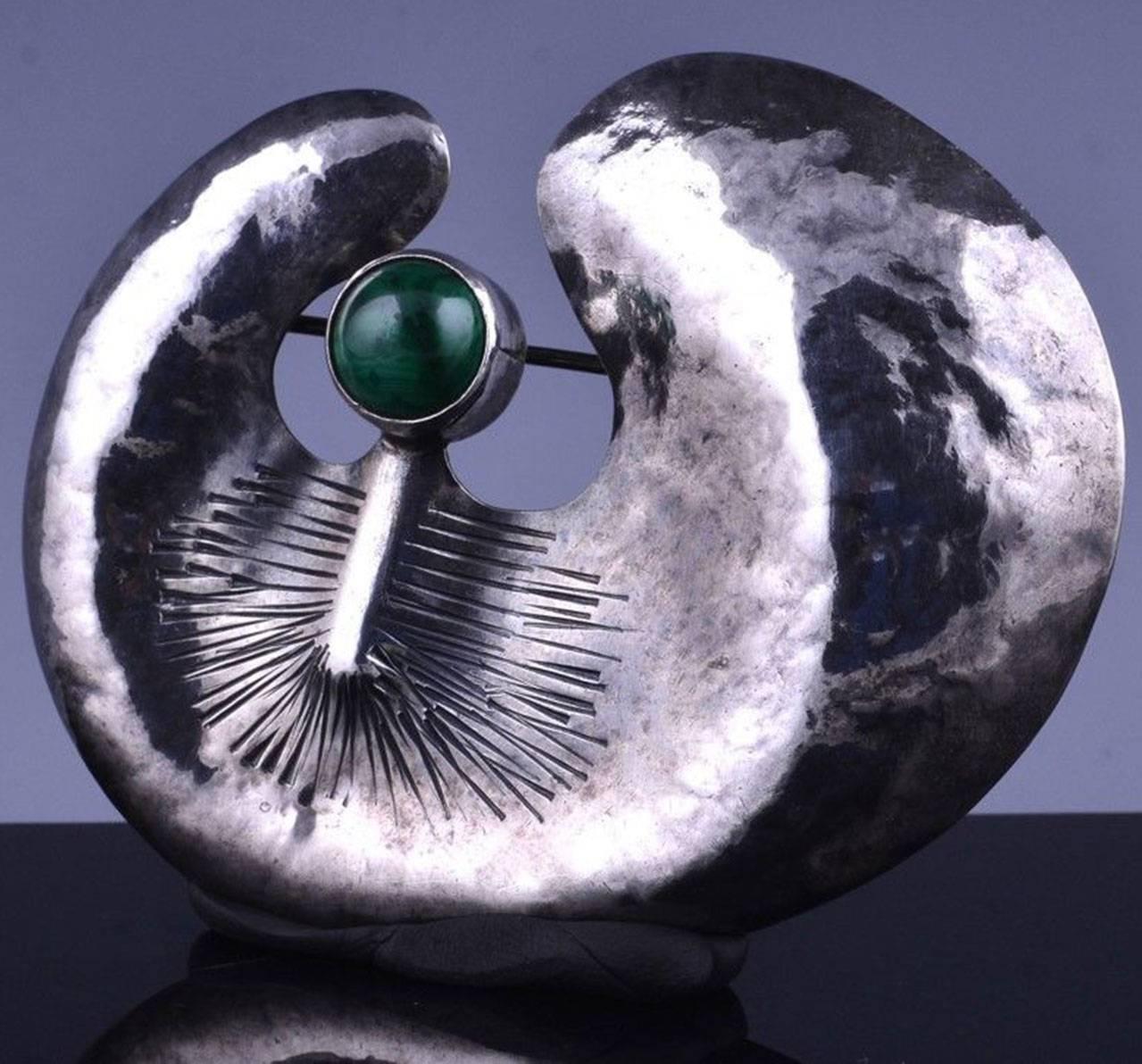 Amazing large Modernist hand crafted and hand-hammered Runway brooch set with a malachite cabochon stone. Hallmarks correspond to Poland 925 along with a maker’s mark. Approx. size:  2.88 inches wide x 2.38 inches high; approx. Chic and