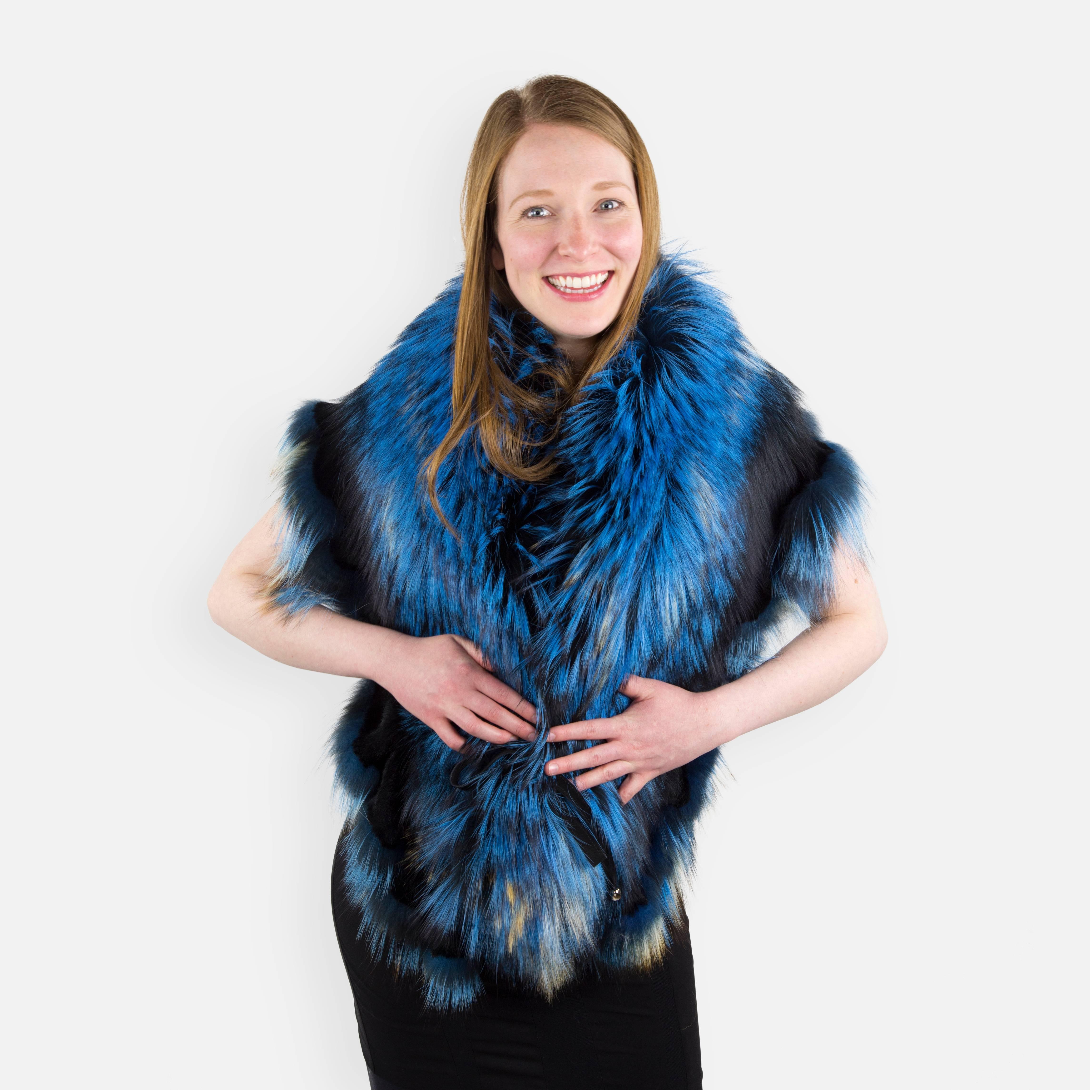 Get in touch with your glamorous side and stay warm, pampering yourself with this Luscious oversized rich blue stole, designed in Italy and crafted from the finest dyed Canadian Finn Racoon and Fox fur, fully lined and embellished with playful