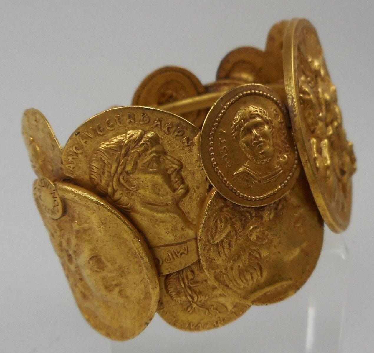 Askew London signed Antiqued Gold Plated Hinged Bracelet featuring Gold plated Brass Roman style Coins. Approx. 1.75'' Wide. Classic, Stylish, Beautiful and Fun to Wear! 
