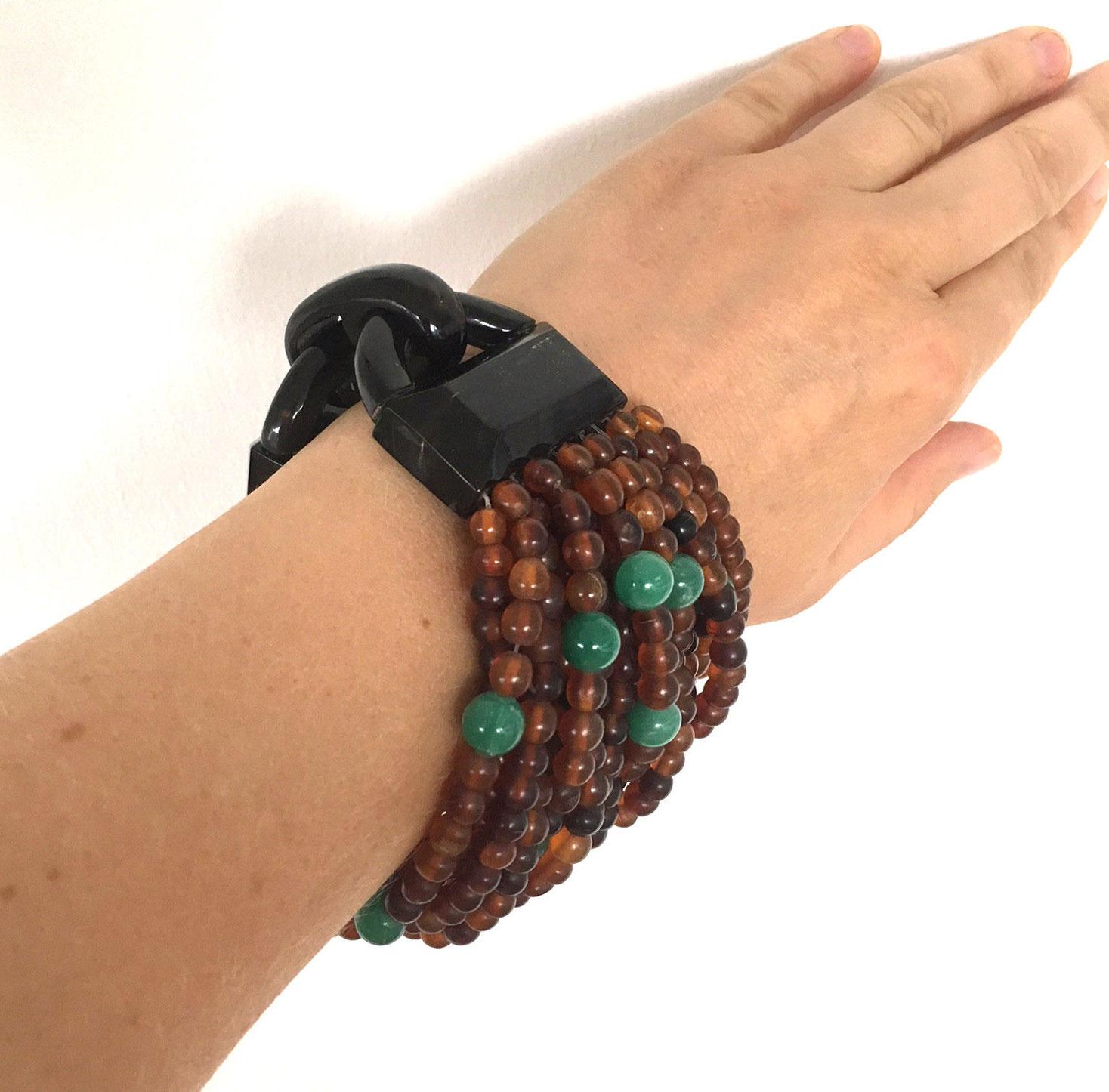Designer Bracelet by husband and wife team Gerda Lynggaard & Nikolai Monies of Copenhagen Denmark, known for large scale high end costume jewelry incorporating natural materials; Rows and rows of rich Natural Horn Beads are gathered with an Iconic