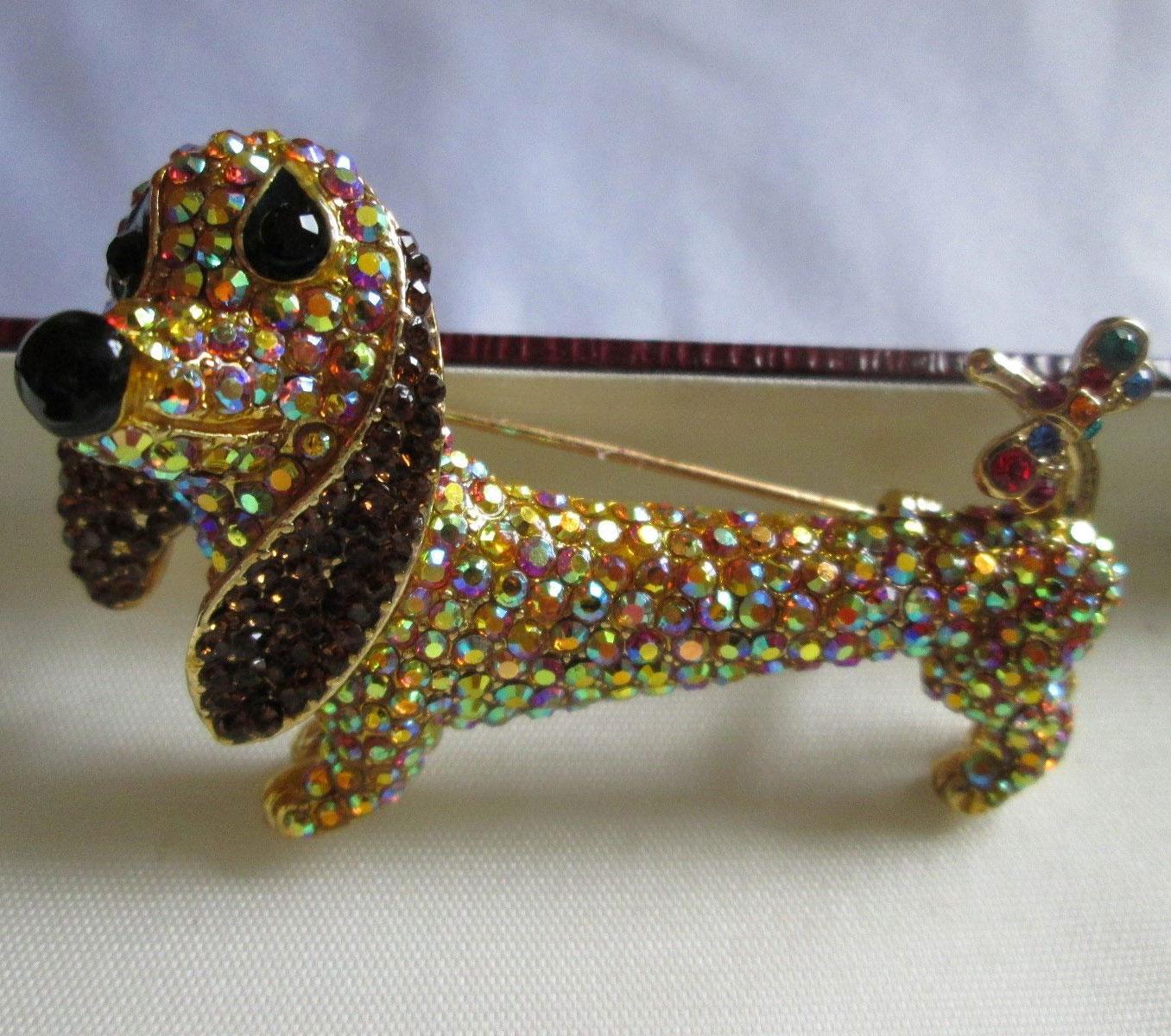 Delightful signed Butler & Wilson Dachshund with drooping ears Brooch Pin encrusted from head to toe with sparkling multi-colored faceted CZ, jet glass eyes safely set in teardrop sockets, jet nose and a pretty colorful amethyst, ruby, sapphire,