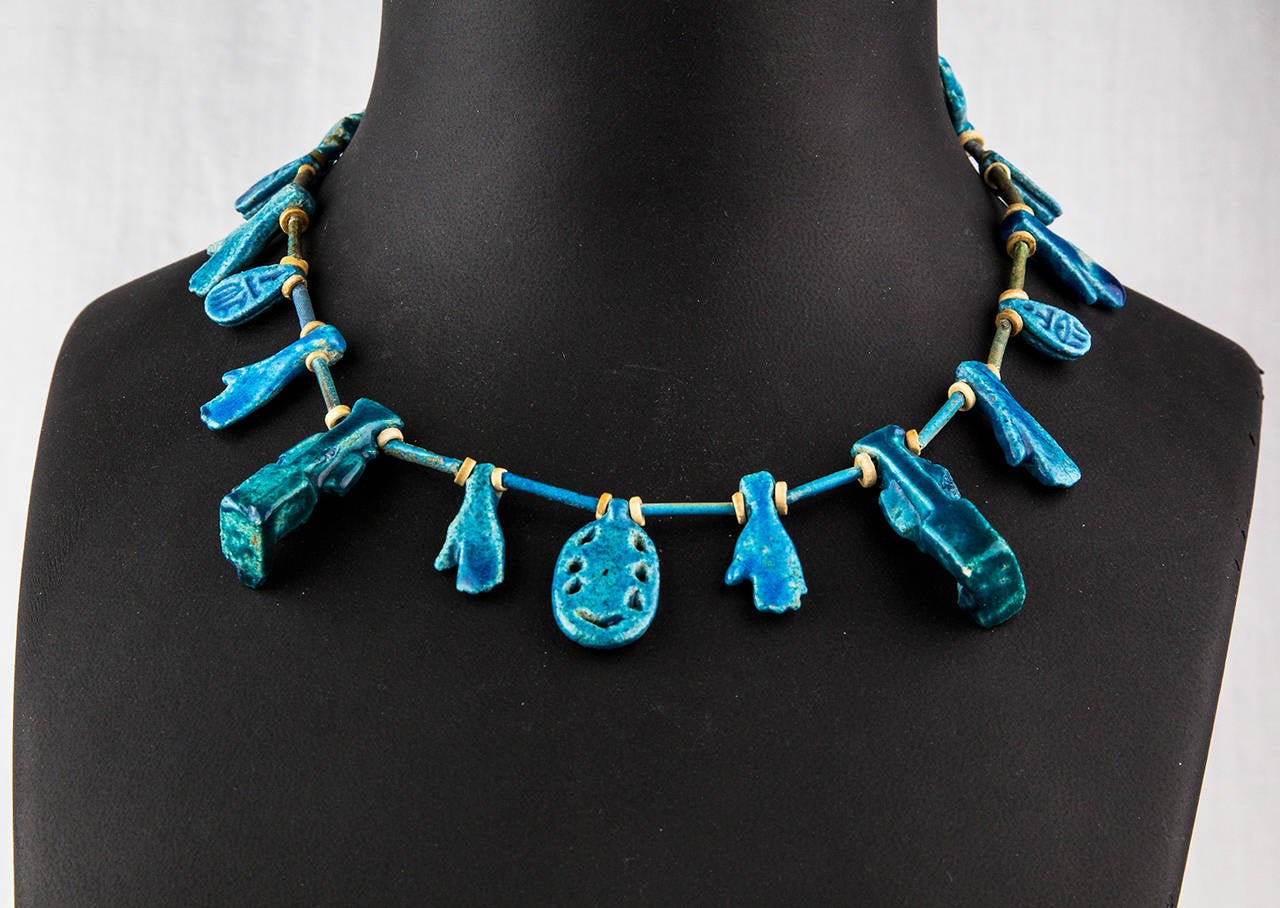 Antique Group of 15 Amulet charms, Faience with blue glaze, strung as a Necklace, held by a Sterling Silver barrel style clasp, incorporating Scarabs, Beetles, Deities and The Hamsa (a palm-shaped amulet, popular, recognized and used as a sign of