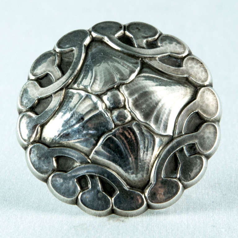 Very rare Georg Jensen large circular Sterling beautifully stylized leaf and shell form brooch with a nice patina. Marked on back: STERLING DENMARK 16 with Georg Jensen in a dotted oval, used between 1933 and 1944. The highly detailed hand-chasing