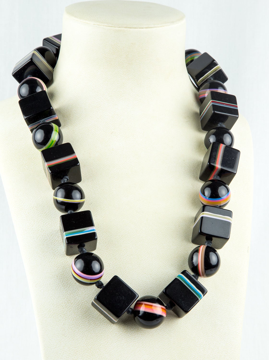 Dynamic Chunky Necklace comprised of large Black Square 24mm Cube and 24mm round Beads with banding, the colors of the Rainbow. Approx. total length: 28”. Classic and Dramatic!