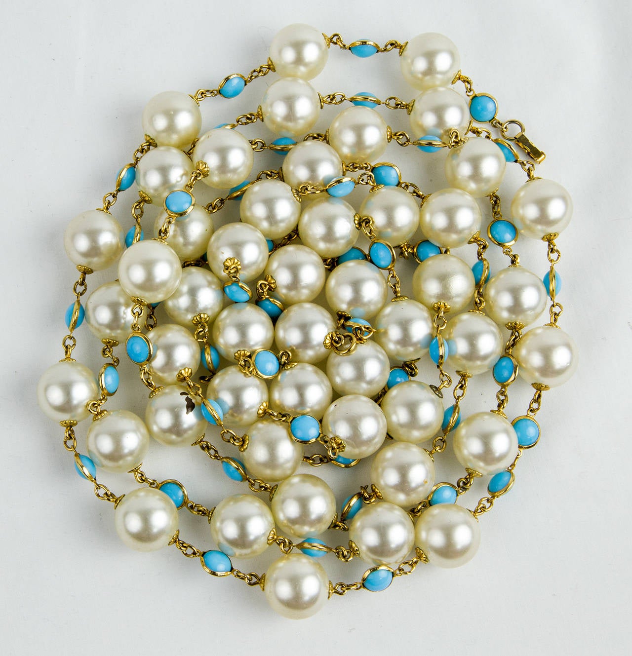Versatile long Statement Necklace of large (18mm) faux Pearls inter-spaced with Turquoise glass stones set in bezel gold-tone setting. Can be worn as a very long single or… doubled and tripled for a shorter multifaceted look; Beautiful when worn