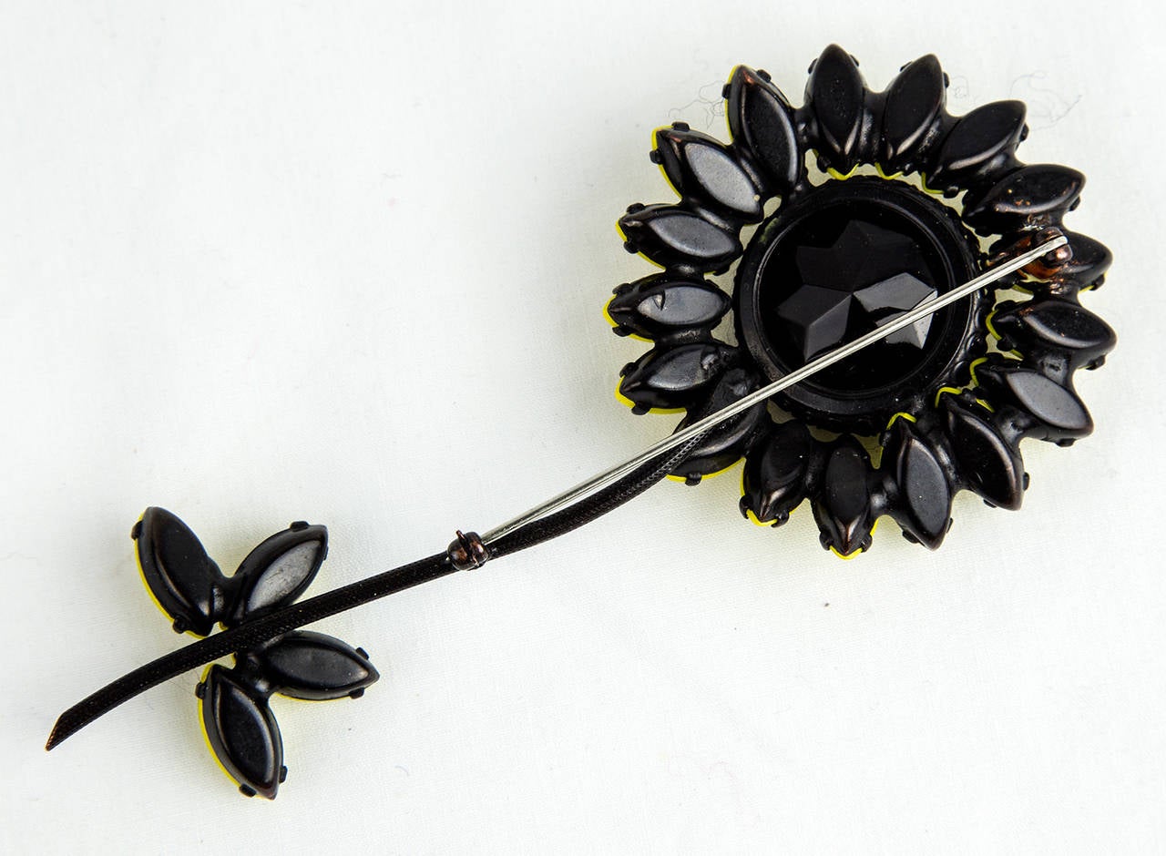 Outstanding Long-Stemmed Flower Pin, centering a faceted black Jet stone and surrounded by yellow Navettes all prong set; Japanned Finish; Signed: WEISS; approx. size of pin: 4.75” long; C1960s