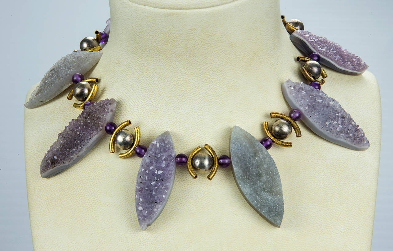 Glam Rocks! This Runway necklace features eight Genuine Natural Gem Amethyst Druzy Quartz inter-spaced with round Amethyst and Gilt Sterling Silver demi-lune  beads; Necklace held by a circular Gilt Sterling Silver Clasp.  The tapered Marquise
