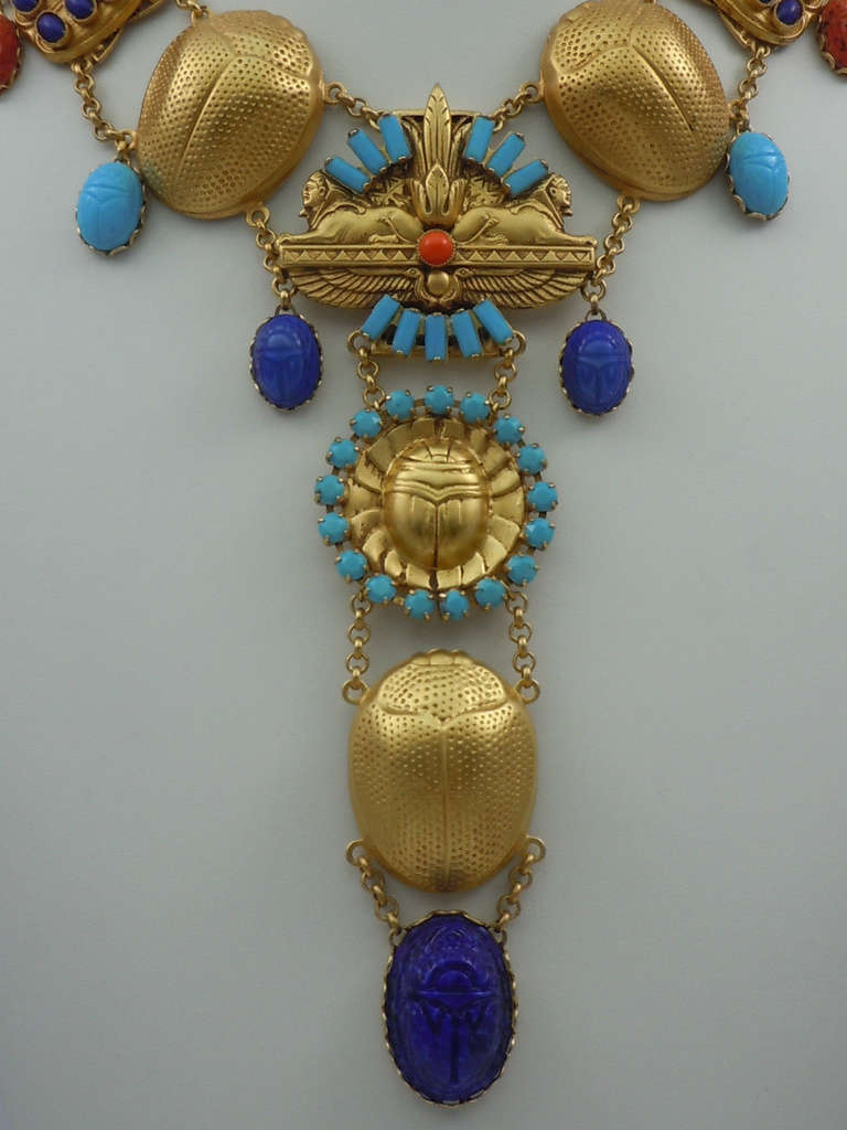 Stunning Askew London Signed 'Egyptian Revival' Sphinx and Scarab Drop Necklace.  Antiqued Gold Plated Double Sphinx Brass Stamping Decorated With Turquoise Glass Baguettes And Coral Glass Cabochon. Sphinx Part Is Linked To A Round Sphinx Brass
