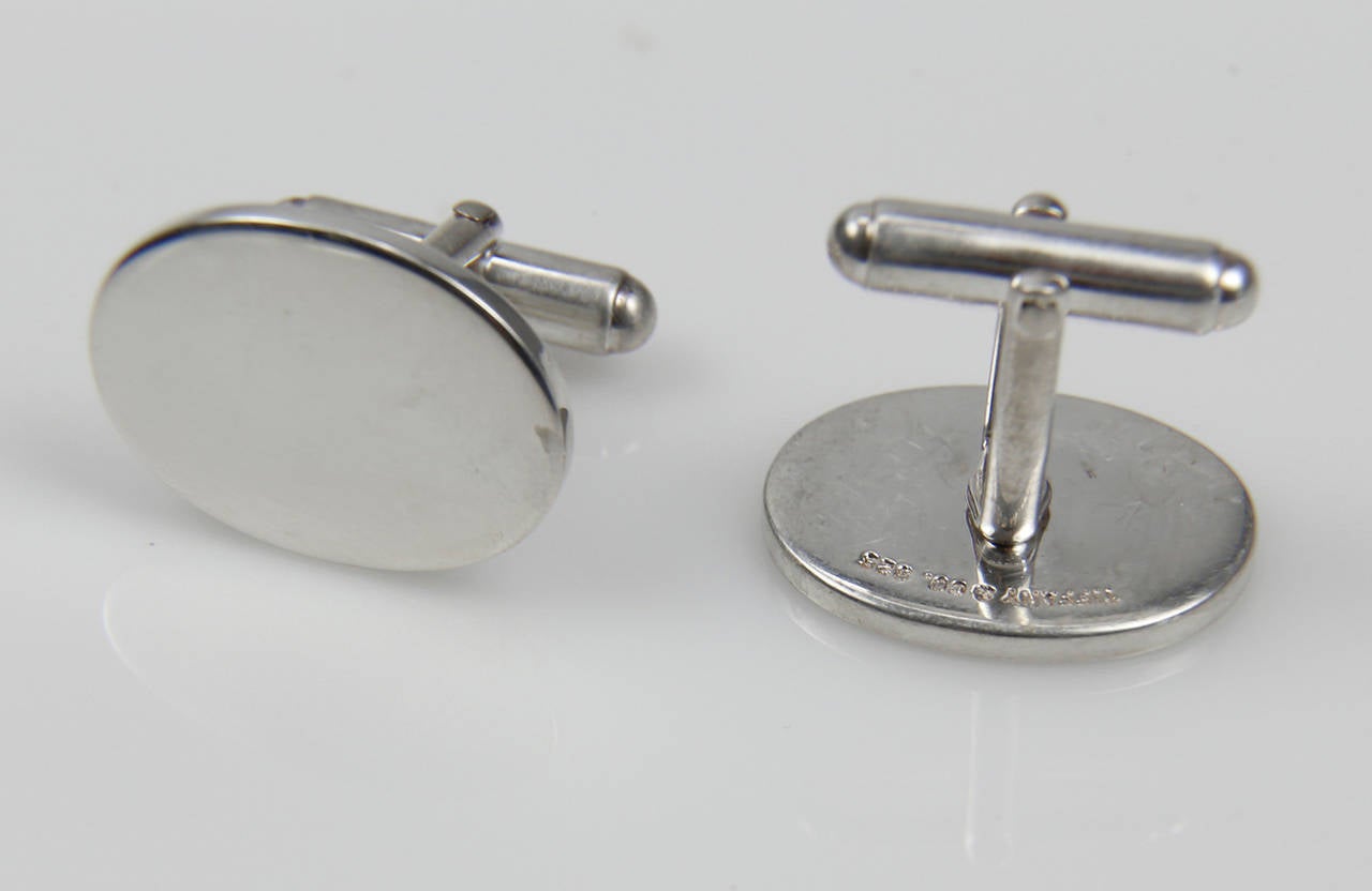 Classic Tiffany & Co. Cufflinks; polished oval shapes; crafted in Sterling Silver; marked: TIFFANY & CO. 925. approx. dimensions: 21.5mm x 16.5mm; approx. total weight: 15.5gm. In original TIFFANY & CO. suede pouch. C1960s; Classic & Sophisticated!
