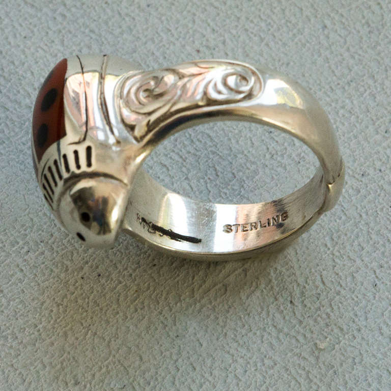 Walter Schluep Red Enamel Sterling Silver Ladybug Ring with decorative side designs on shank; top of ring measures approximately 19 x 12mm; approximate ring size 6.5; all handmade; signed: SCHLUEP STERLING and WS his trademark signature. Artist #