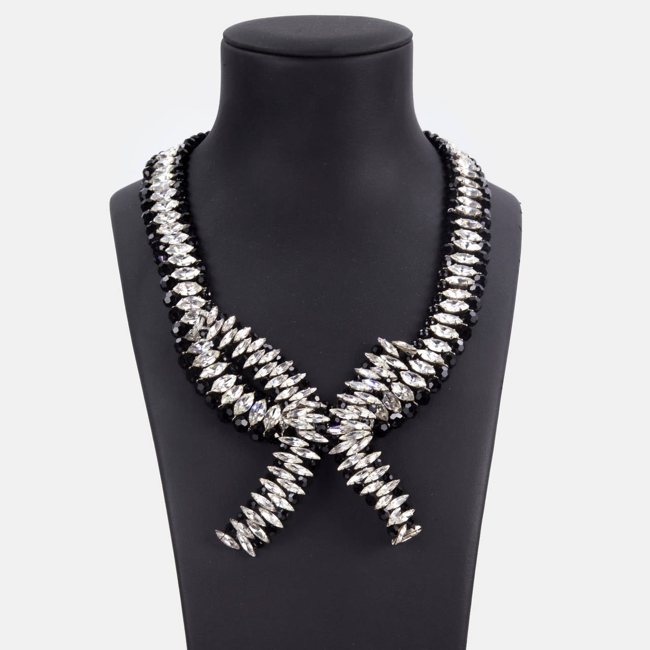 Sensational signed Guy Laroche Necklace featuring prong-set, sparkling Marquise clear  crystals and round facet cut Jet stones in a unique Demi-Lune design; Silver finish; approx. 27” total length x 1” wide, Demi-Lune measures approx. 5” x 4”-6”;