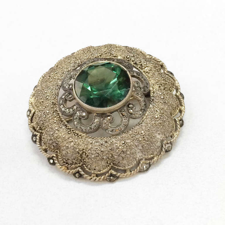 Classic signed Theodor Fahrner Jugendstil round Silver Brooch; gilded Silver & synthetic Green Spinel; Approximate diameter measures 1.5 inches. Marks: Fahrner TF 925; circa 1900s; Pforzheim, Germany. Stylish and Timeless!