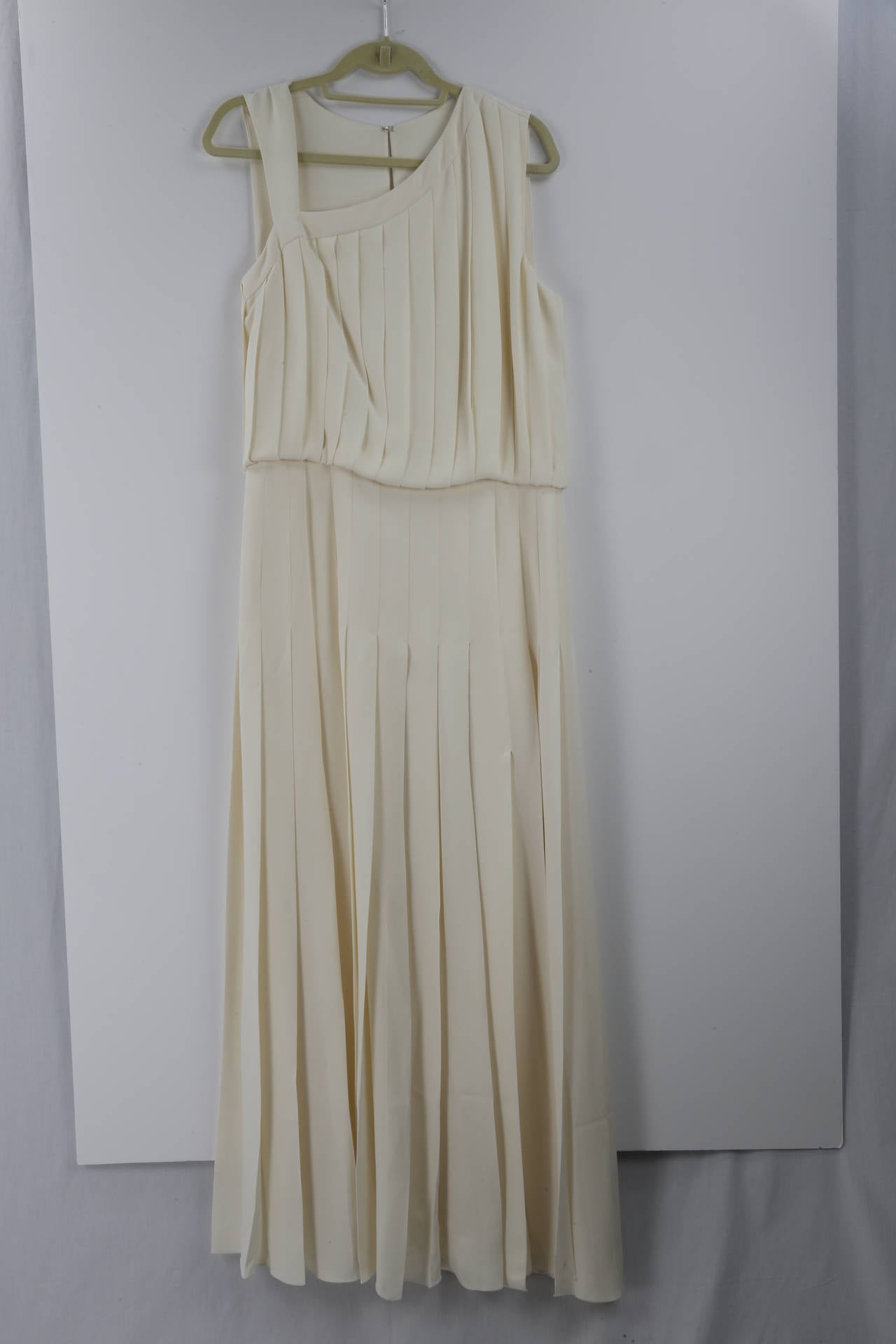 Beautiful Signature Micro pleated Evening Gown in Classic beige from Mary McFadden's Couture collection. V neckline and V back and side zipper; stunning Gold, Brown and Silver Bead work; skirt portion is straight and unlined, the bodice is lined in