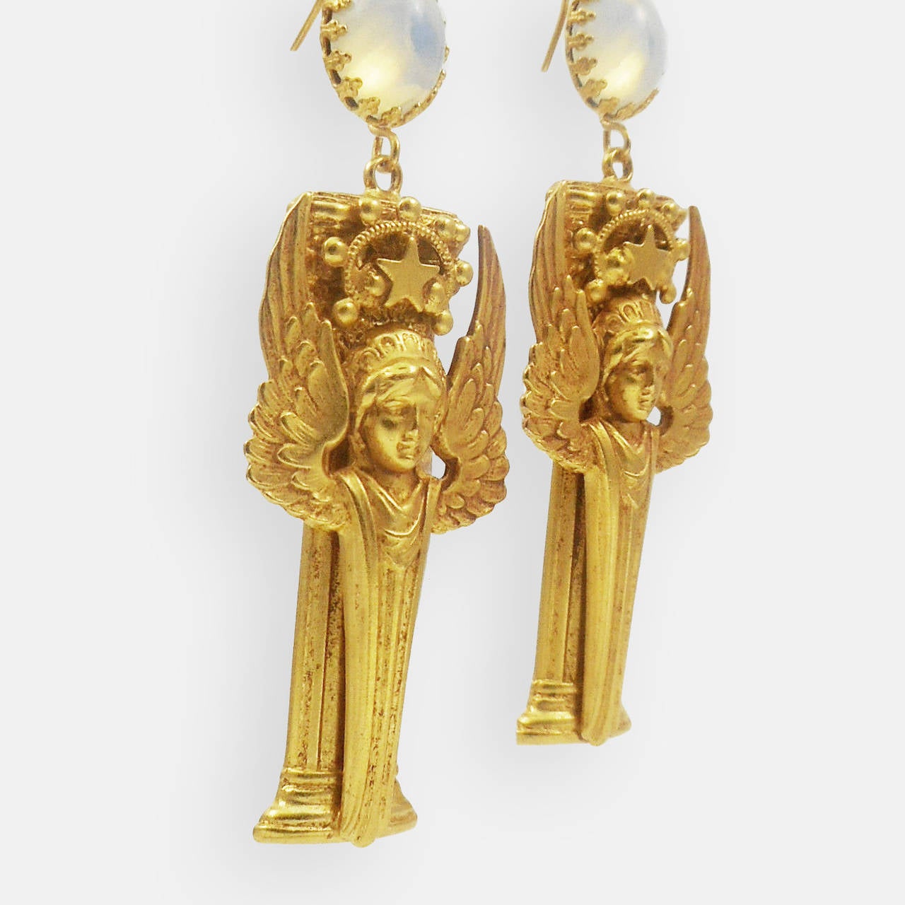  Wonderful pair of Dangle Earrings featuring Winged Goddesses  with Columns and  Stars and Scroll Decorations; Antiqued Gilt Brass. Goddesses are suspended from Hook Earring fittings set with Opaline Glass Cabochons in Crown Edged Settings. Earrings
