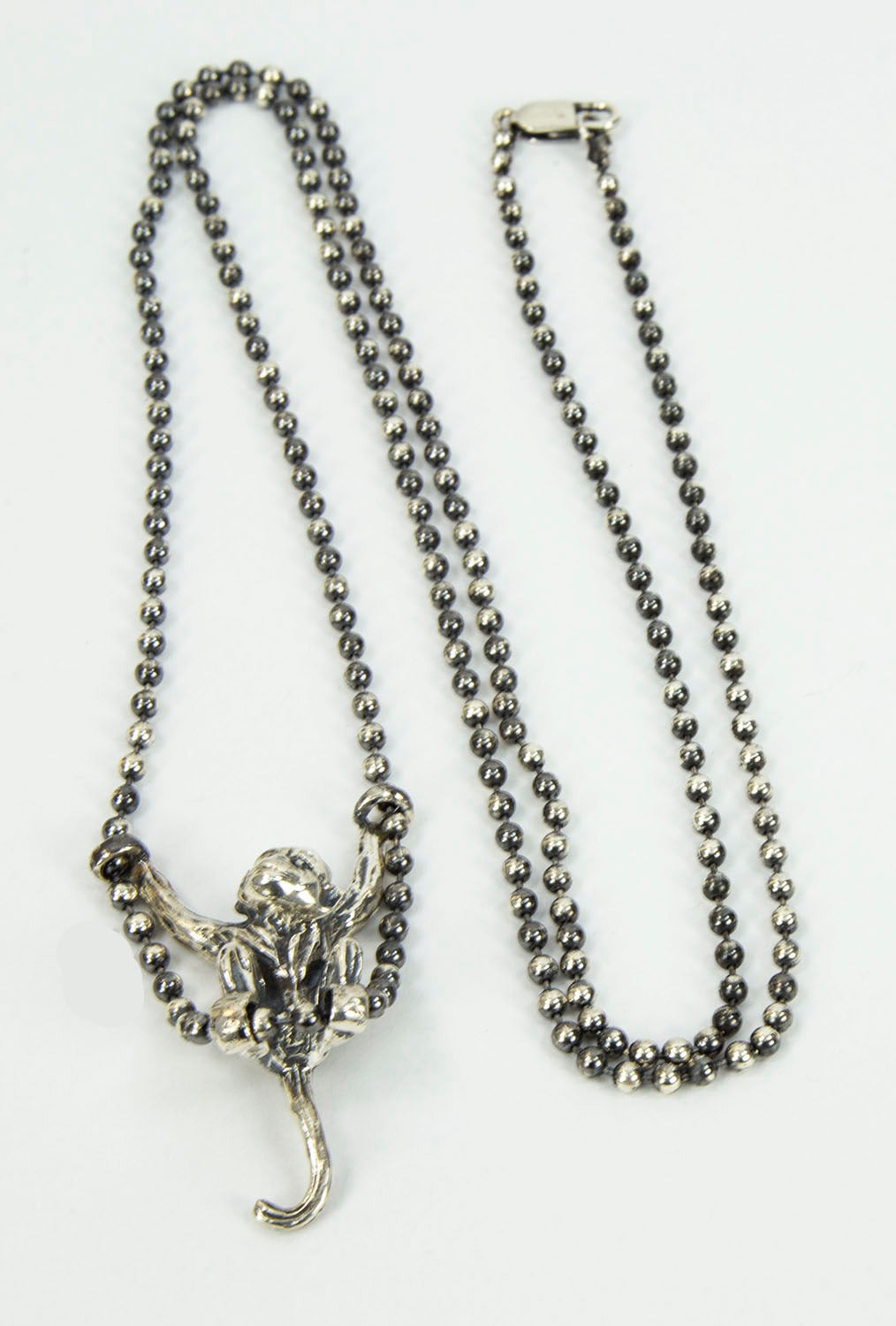 Adorable Monkey swinging on a long Ball Chain; all in oxidized solid sterling silver; measuring approx. 38” long; monkey measures approx. 2” long x 1.25” wide. For the Child in All of Us!