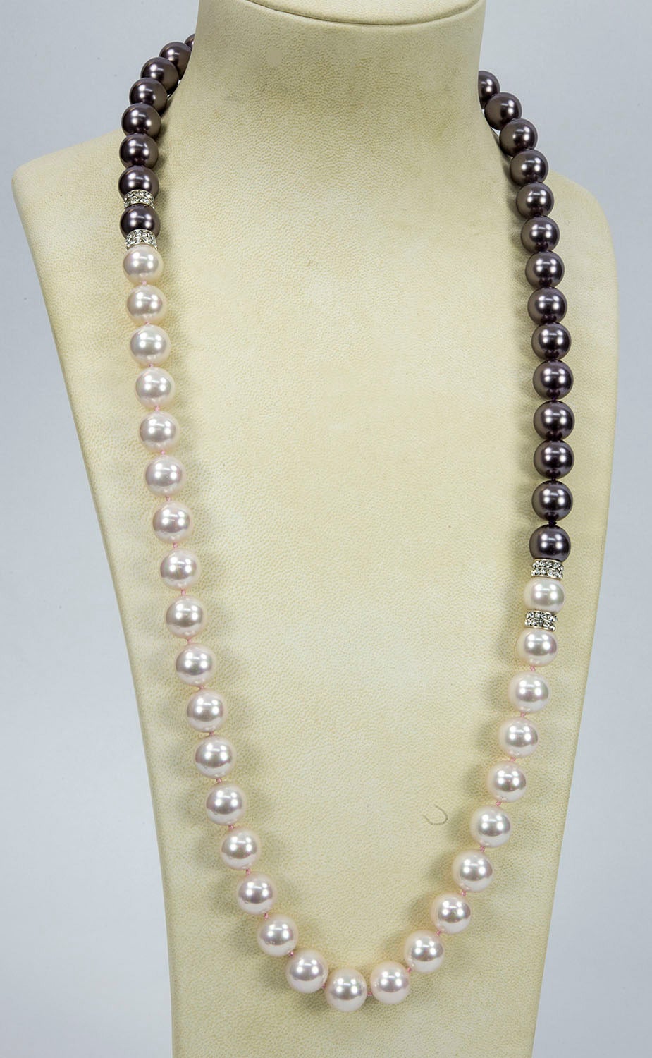 Striking lustrous 14mm Black and White Pearl Runway Necklace, enhanced with CZ encrusted rondelles; hand knotted with matching color silk threads, Necklace measures approx. 32” long. Go anywhere in style with this Chic and Timeless strand of Pearls!