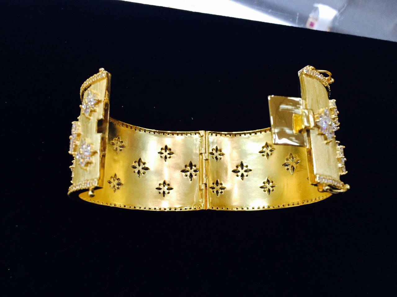 Gorgeous Textured Gilt Silver Cuff Bangle Bracelet studded with CZ snowflake designs and CZ encrusted outer borders. Push clasp and double ‘8’ safety. Marked: 925. Fits average wrist size. Interior measurements: 6.5” diameter x 1.5” wide”. More