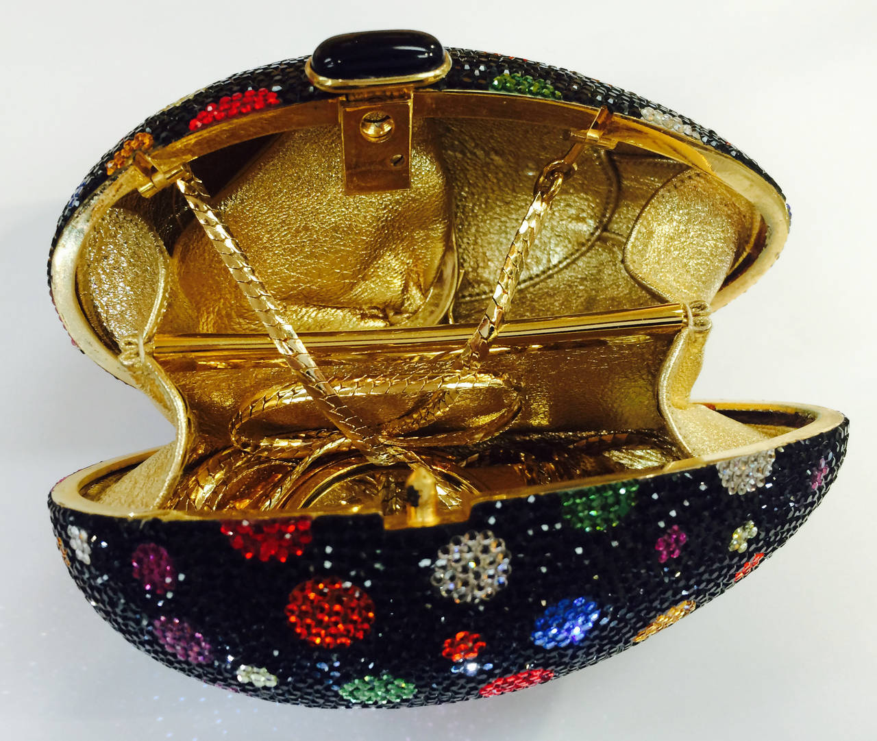 Fabulous Judith Leiber Egg Minaudière Clutch encrusted with Swarovski Crystals; Black ground enhanced with vibrant colorful spheres; stunning gold leather interior; Gold chain strap. It appears not to have ever been worn; no signs of wear or tear;