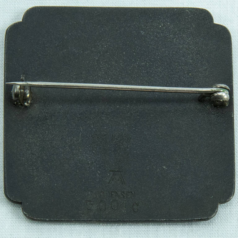 Georg Jensen darkened Iron ground Brooch inlaid with Sterling Silver. Designed by Arno Malinowski; marked: GEORG JENSEN 5001C and the Arno Malinowski logo signature; Designer: Arno Malinowski (1899-1967), inspired by Japanese mixed metal techniques,