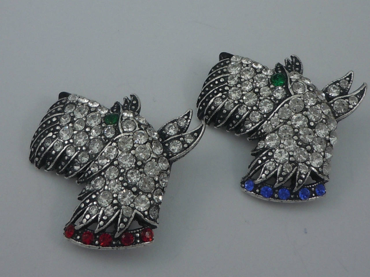 Featuring a pair of Adorable Terrier Head Brooches; Askew London Antiqued and set with Crystal Chatons and green eyes; red & blue Chatons set Collars; each brooch measures approx. 1.25'' across. Add your own Style, Fun and Pizzazz to any outfit!