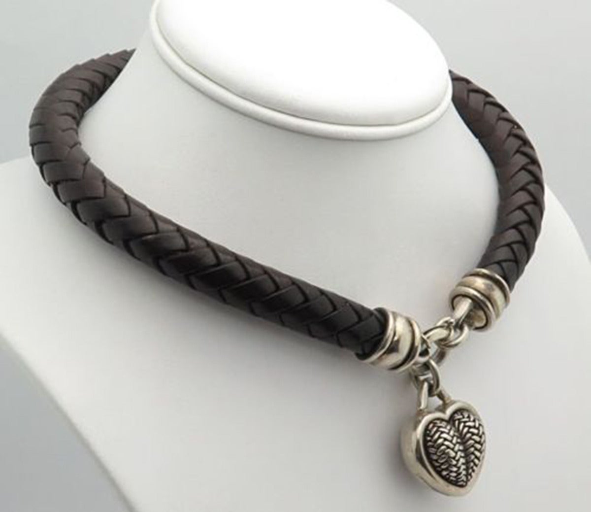 Featuring a Stunning signed BKC Sterling Silver Puffy Heart in a basket weave design, on a thick braided brown leather choker necklace, measures approx. 16