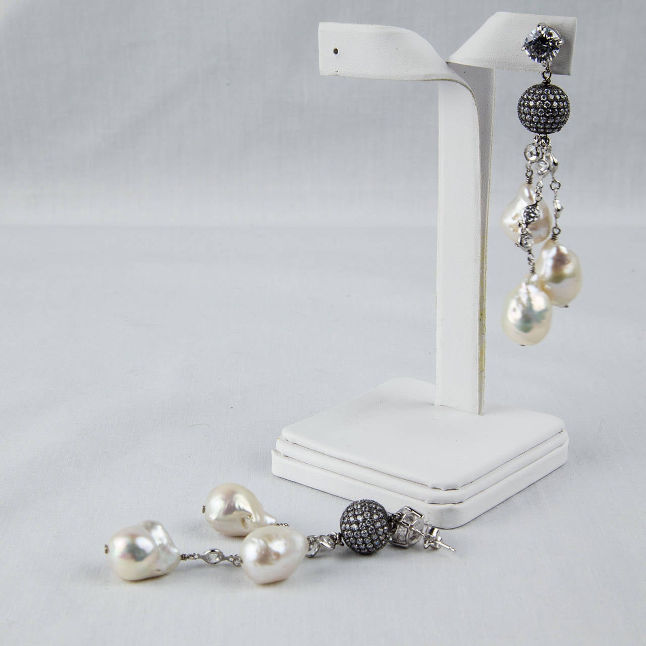 Sensational! Each earring features a solitaire CZ, suspending a Black Rhodium glittering CZ encrusted ball, CZ chain and 3 Cultured Freshwater Baroque Pearls; approx. length of each 3