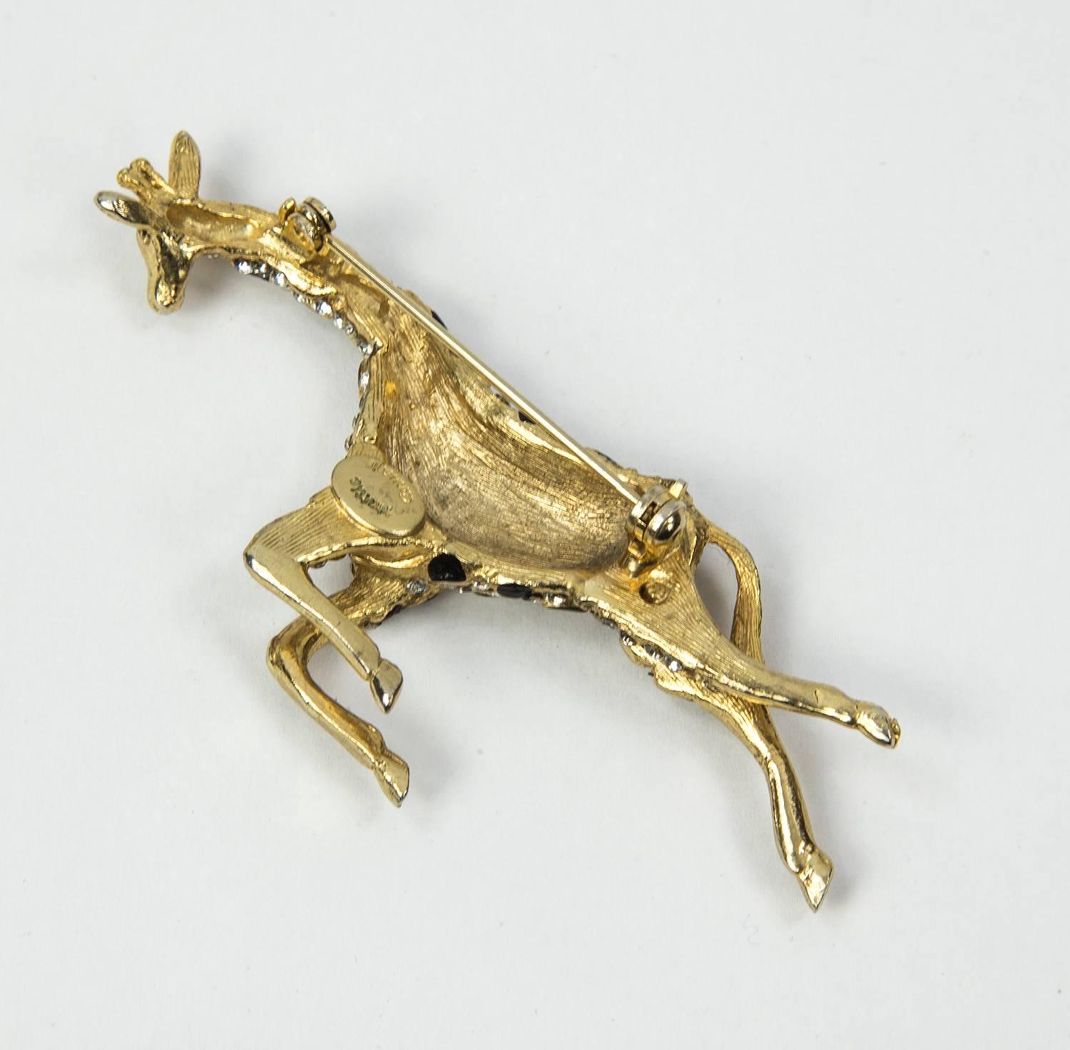With her rhinestones flashing in the sun, this delightful giraffe is running for her life! Or so it would appear by her mad-cap running style. All 4 legs in motion, tail and head are all rendered in polished gold tone, while her body is done in