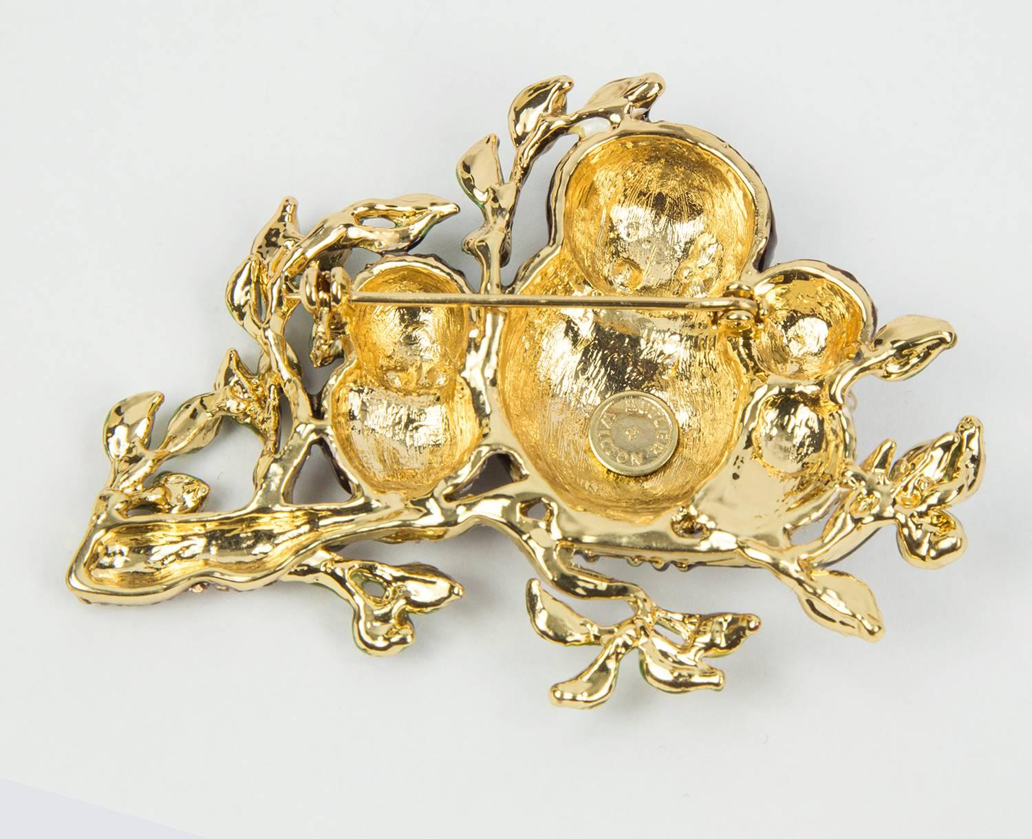 This striking brooch features a Mother Owl and her Babies on a Branch, set with a multitude of glittering crystals and enamel enhancement;  Add sparkling impact to a coat, jacket or even bag with this bold design by Butler and Wilson!
