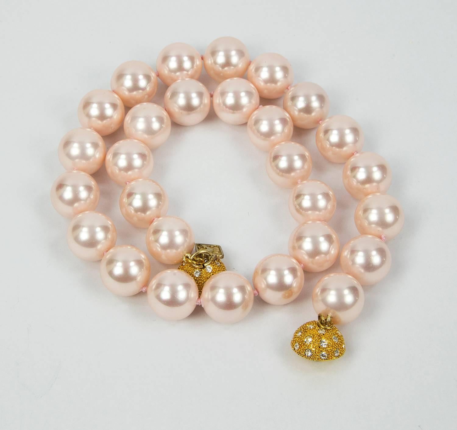 Stunning Lustrous and Luscious Pink round Faux Pearl Necklace; Each Pearl measuring approx 14.5mm; hand knotted with matching color silk thread; held by a round CZ encrusted clasp; approx 17.75” long. Chic and Timeless strand of Pearls, taking you