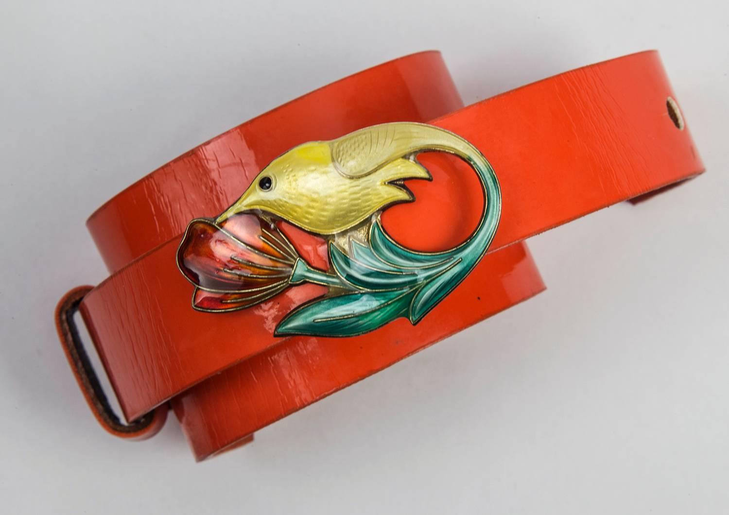 Featuring a David Andersen Enamel Sterling Silver Humming Bird feeding from the blossom of a flower, on an orange Leather Cuff Bracelet; adjustable, fits small to medium/large wrist comfortably. Bird Marked: DA NORWAY STERLING 925S; Circa 1950s.