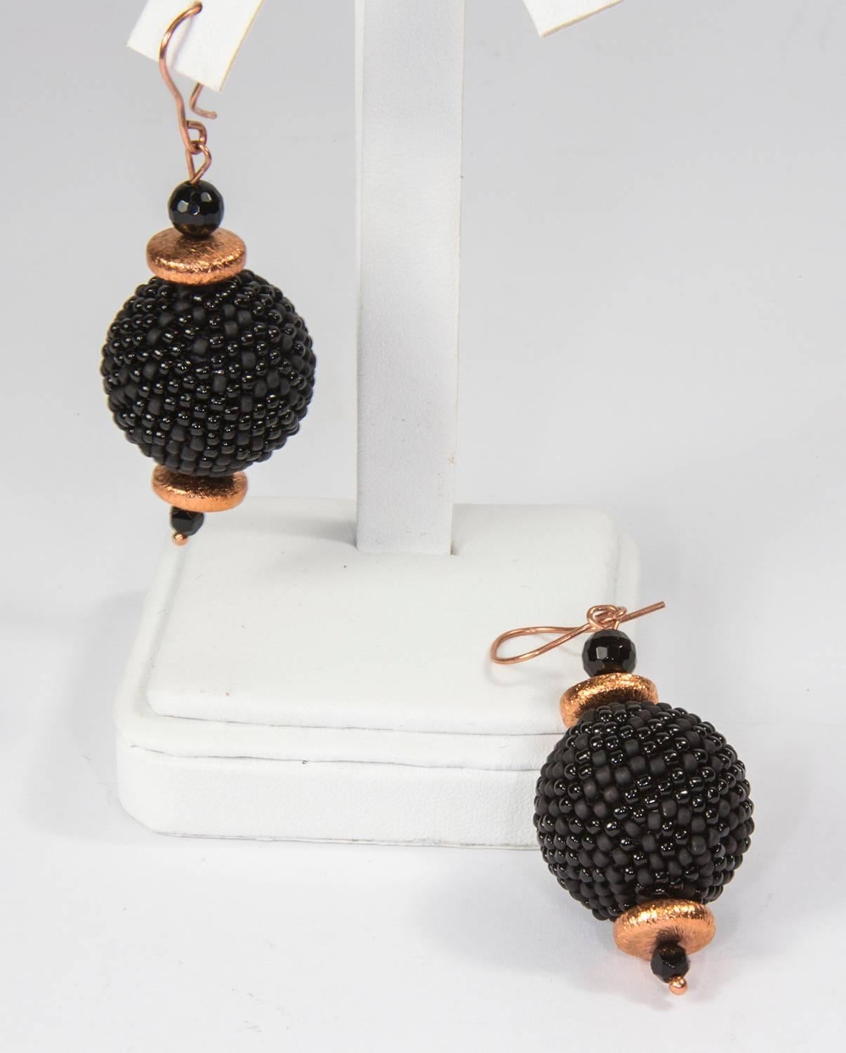 Stunning Large Black overall beaded Beads Drop Earrings, each Bead measures approximately 21.5mm-26mm, inter-spaced with faceted jet beads and Copper rondels,  fitted with copper Sheppard hooks; approx. 2.5” long. Dramatic yet Classic and Timeless! 

